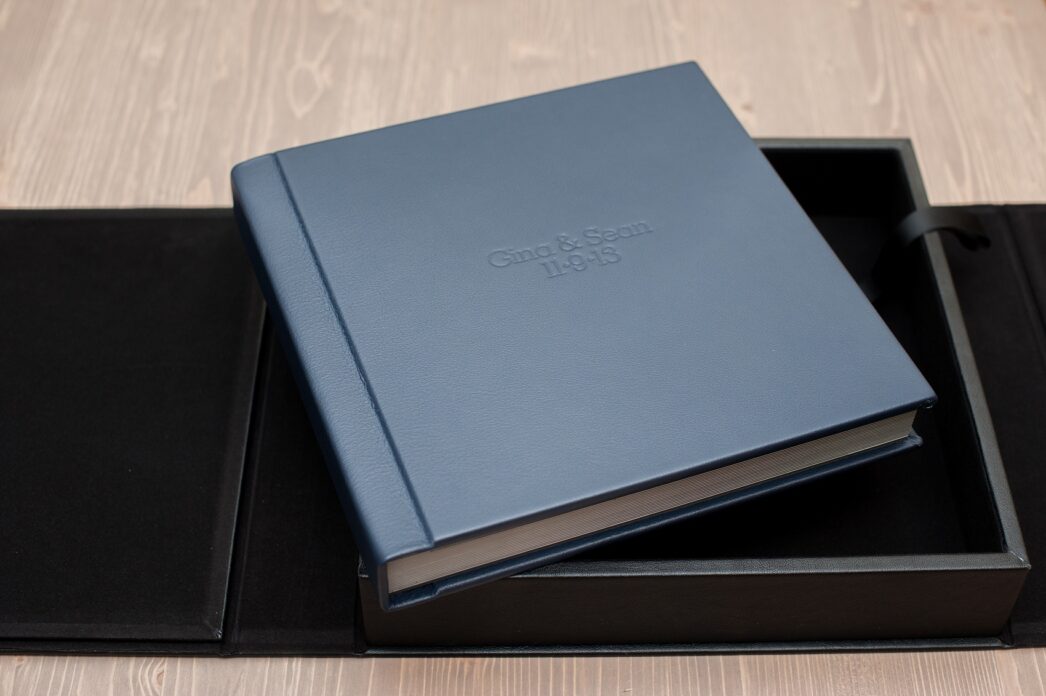 Mikkel Paige Photography photos of a fine art leather Madera wedding album in navy blue. 12x12" album for the bride and groom.