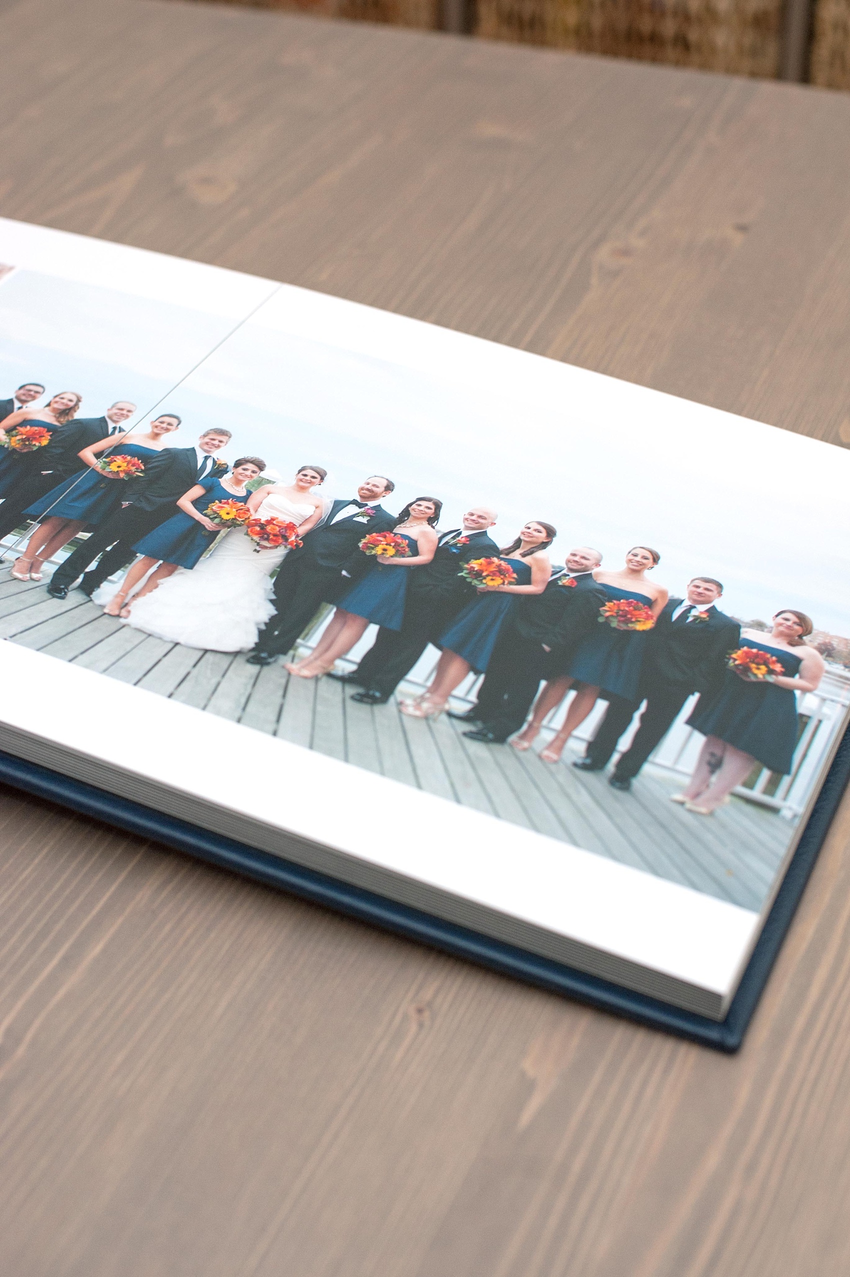 Mikkel Paige Photography photos of a fine art leather Madera wedding album in navy blue. 12x12" album for the bride and groom.