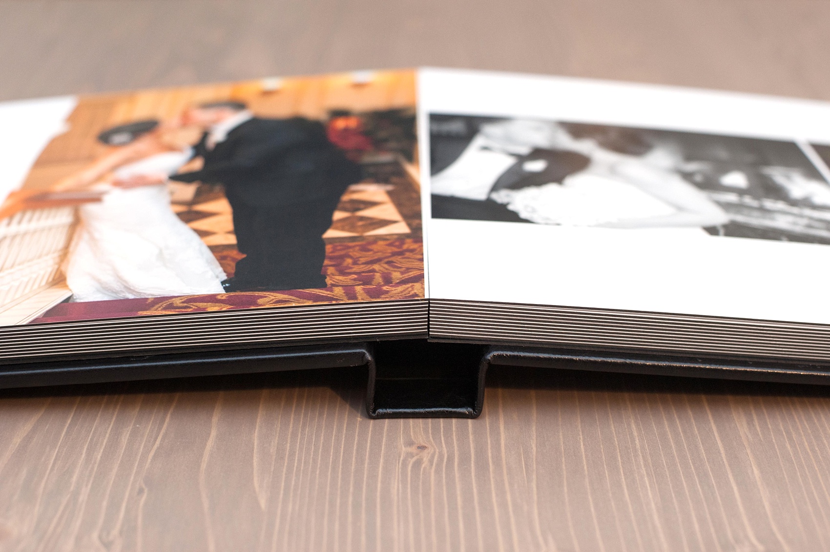 Mikkel Paige Photography black leather, fine-art wedding album option showing a spread.