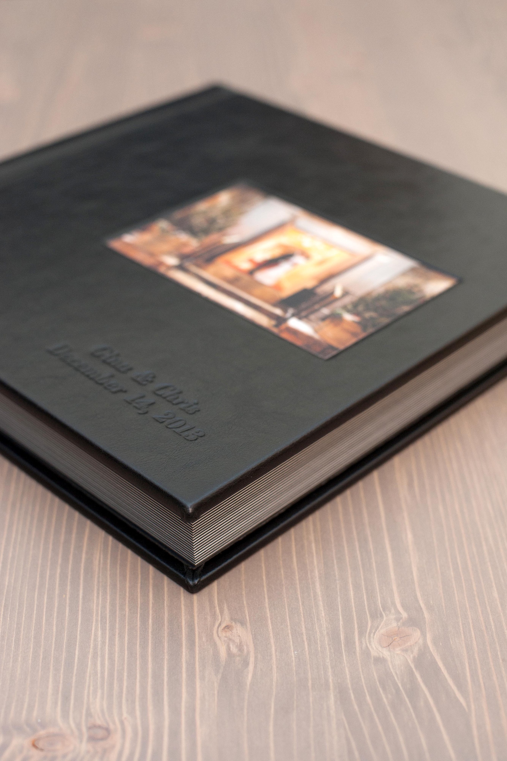 Mikkel Paige Photography black leather, fine-art wedding album option with cover debossing and inset photo.