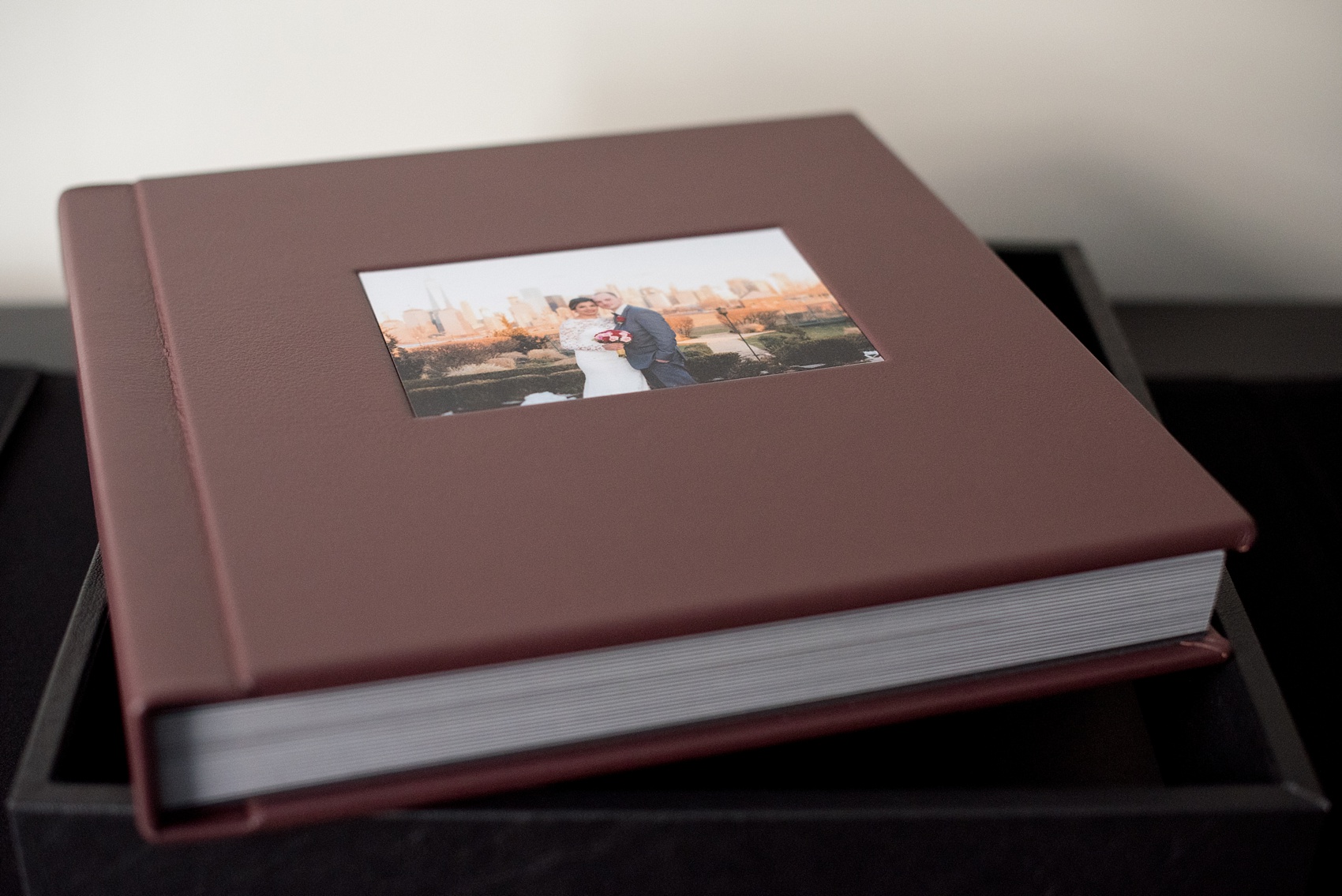 Mikkel Paige Photography photos of a fine art leather Madera wedding album in Oxblood. 12x12" album for the bride and groom with inset cover photo.