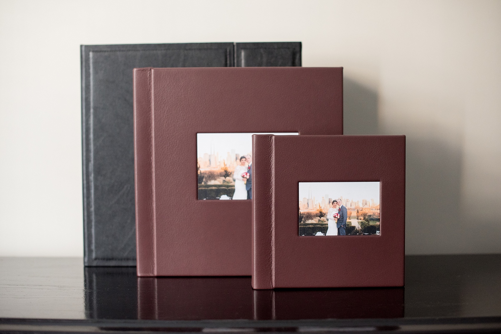 Mikkel Paige Photography photos of a fine art leather Madera wedding album in Oxblood. 12x12" album for the bride and groom and 8x8" parent albums.