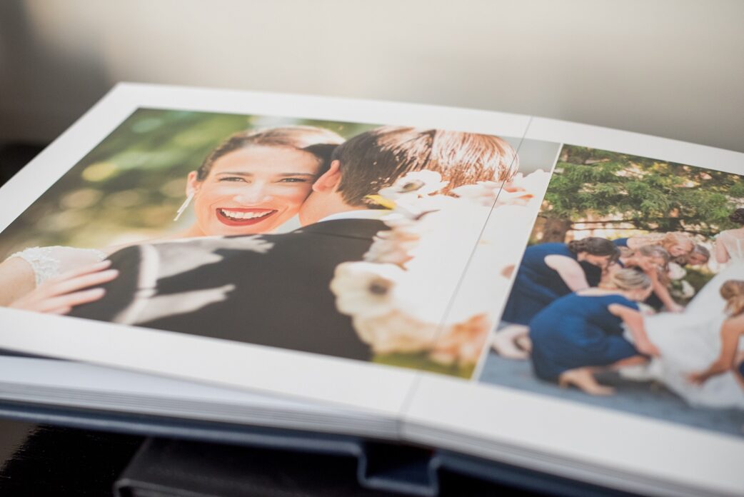 Mikkel Paige Photography photos of a Madera wedding album in navy blue leather. This fine art family heirloom is 12x12" with debossing on the spine.