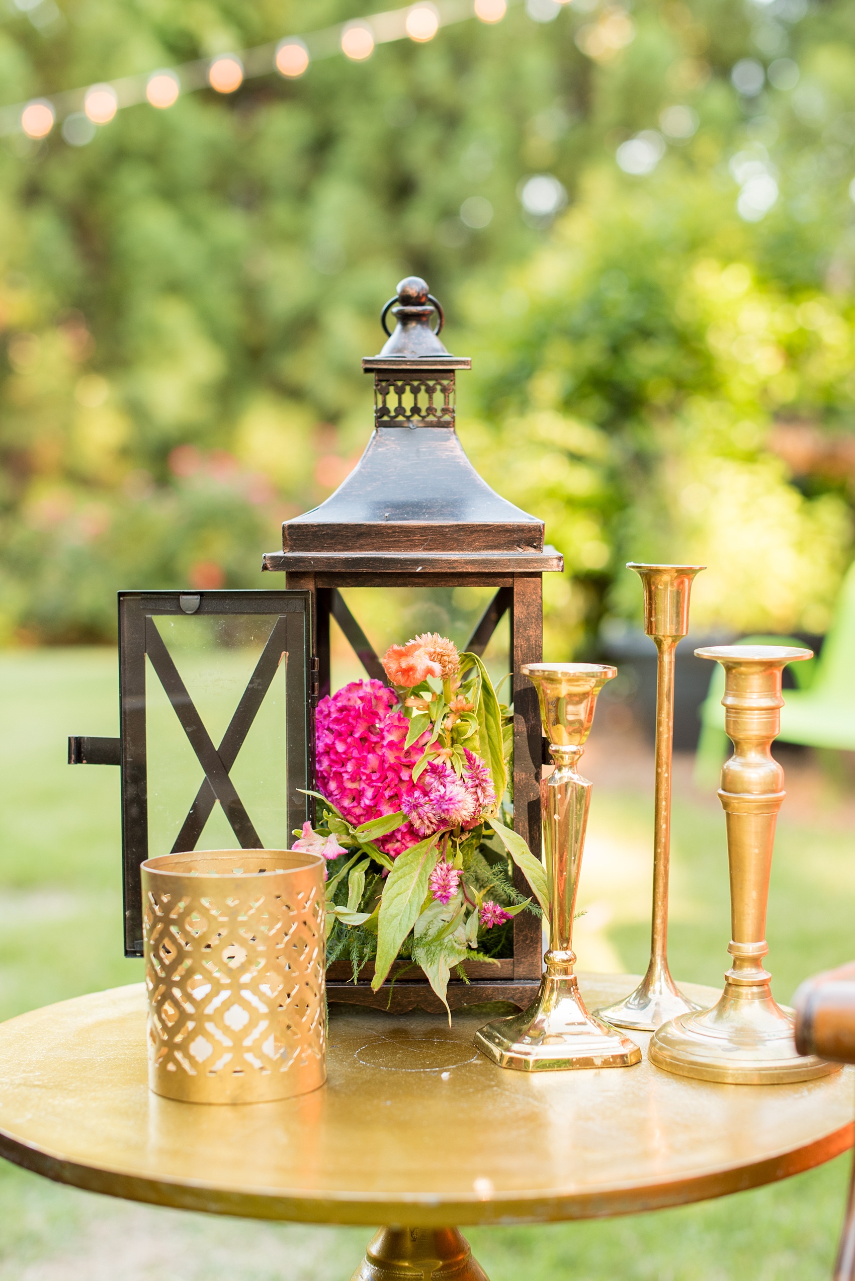 Mikkel Paige Photography photo of Moroccan themed party with flower-filled gold lanterns and bistro lights.