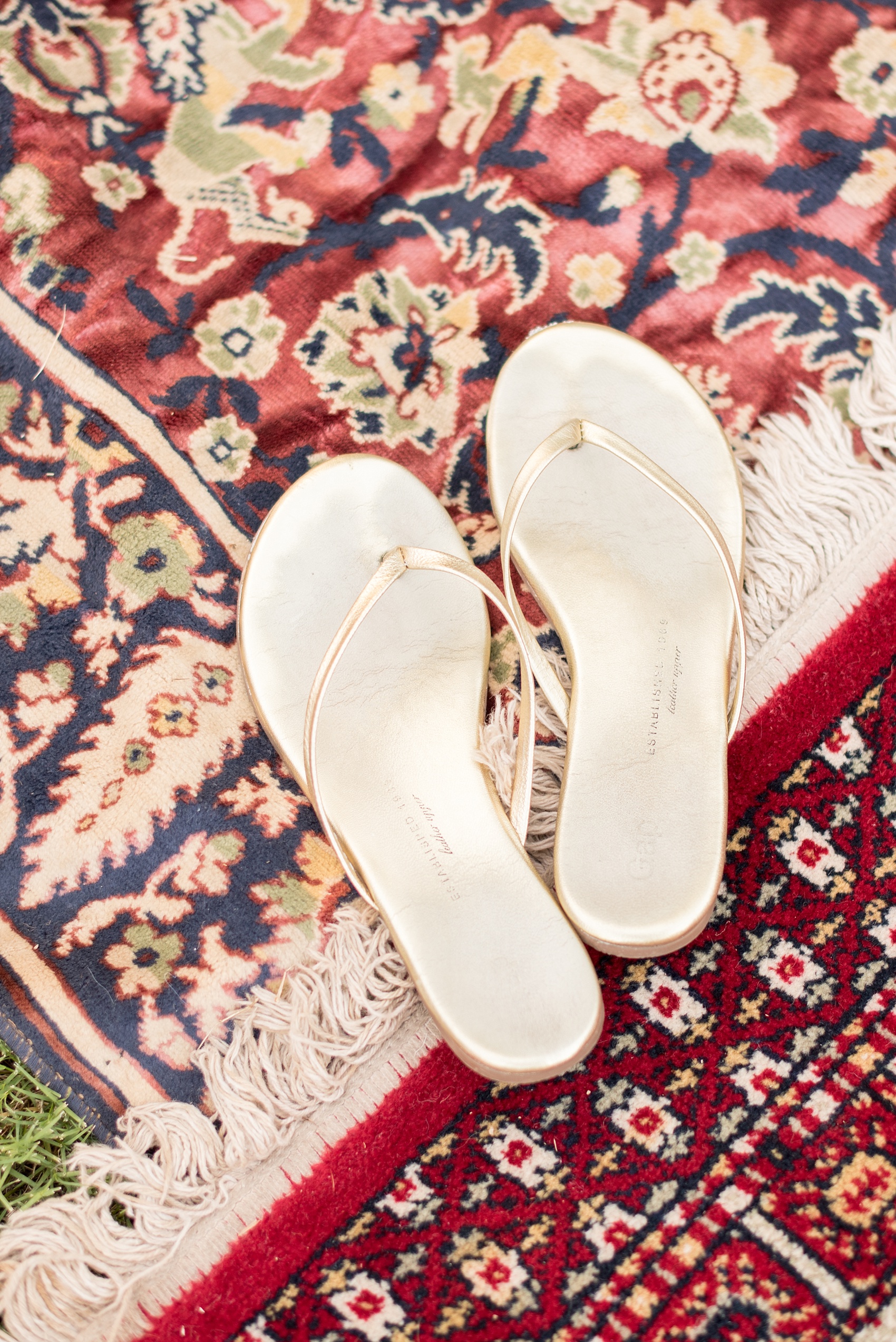 Mikkel Paige Photography photo of Morocco themed party with vintage rugs and gold sandals for festive attire.