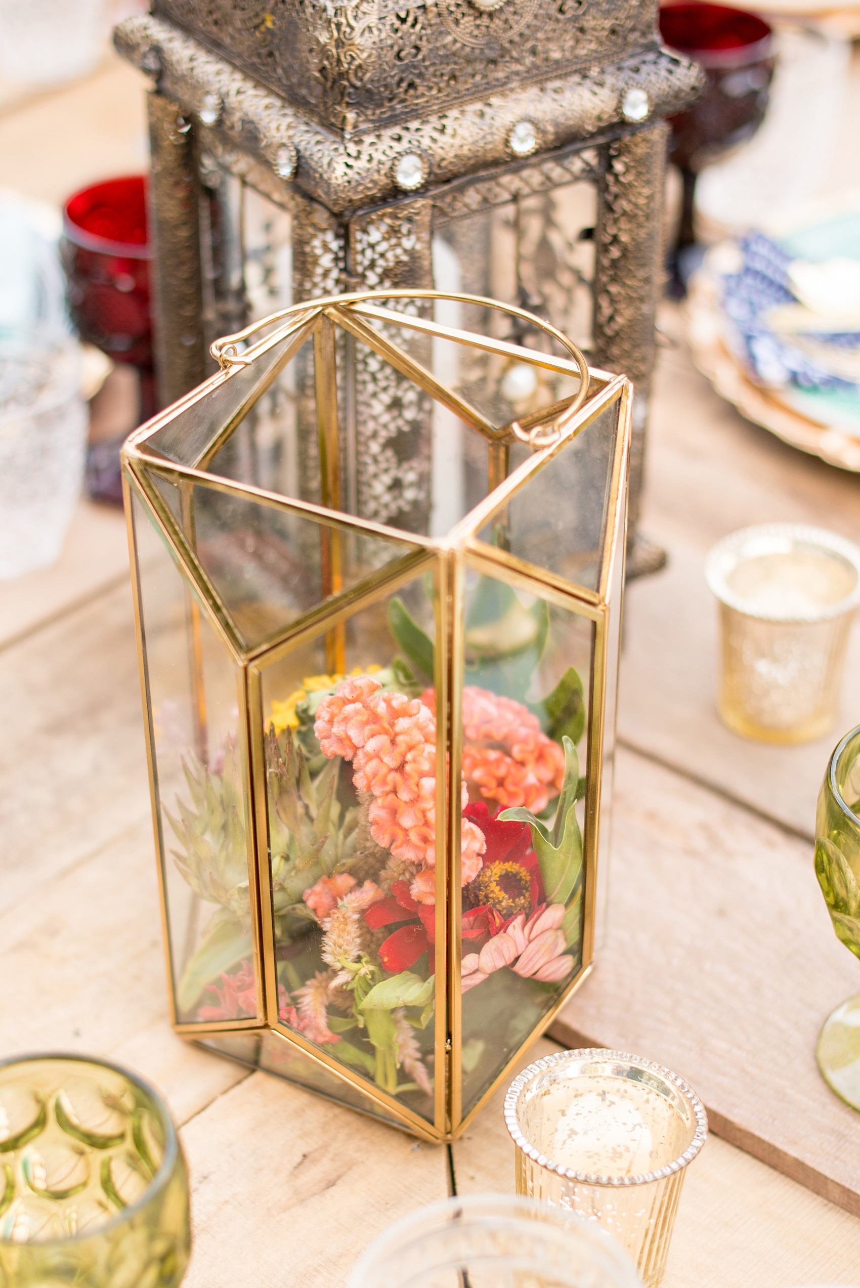Mikkel Paige Photography photo of Moroccan themed party with flowers in gold geometric lanterns.