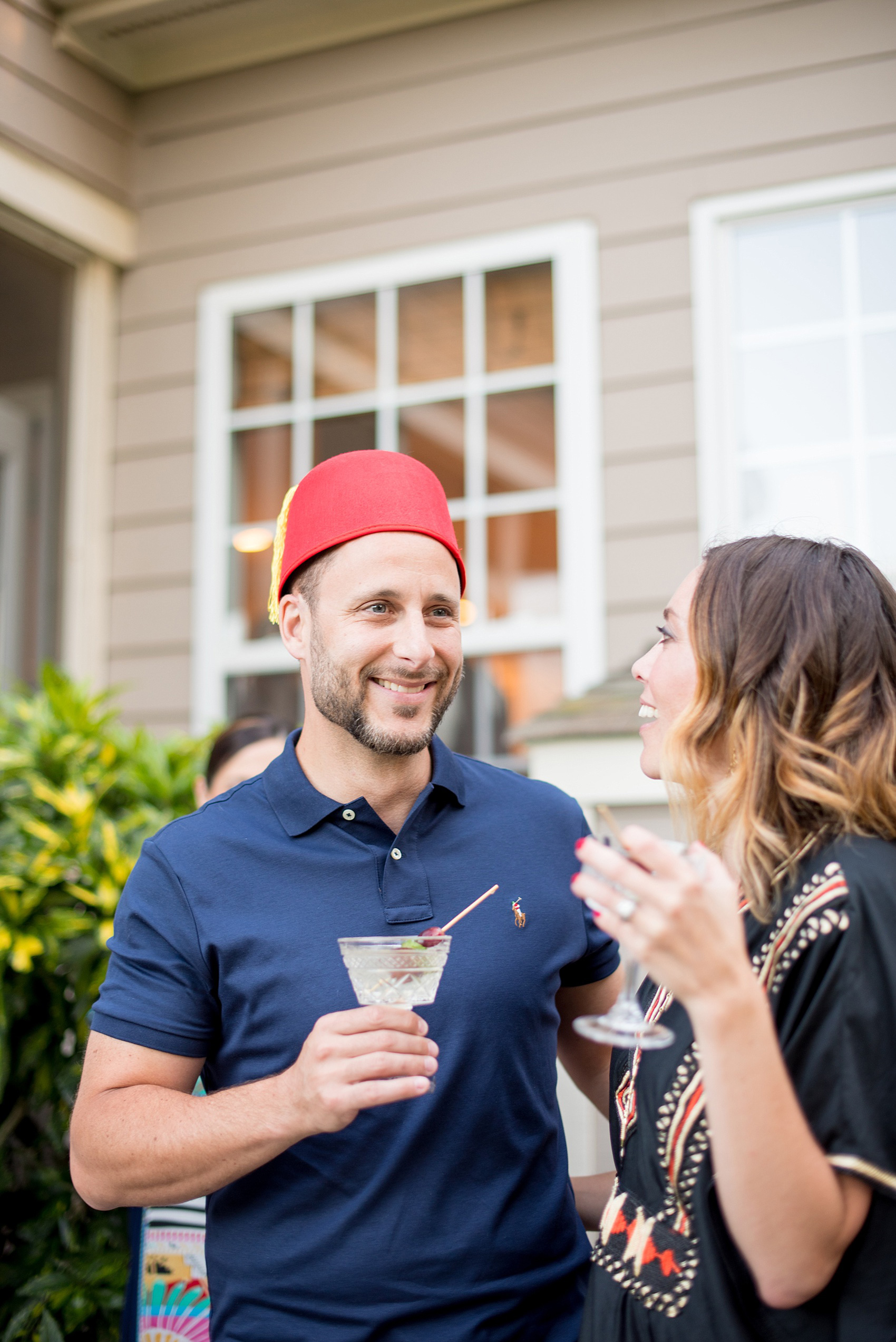 Mikkel Paige Photography photo of Moroccan themed surprise party with fez hat and gin cocktails.