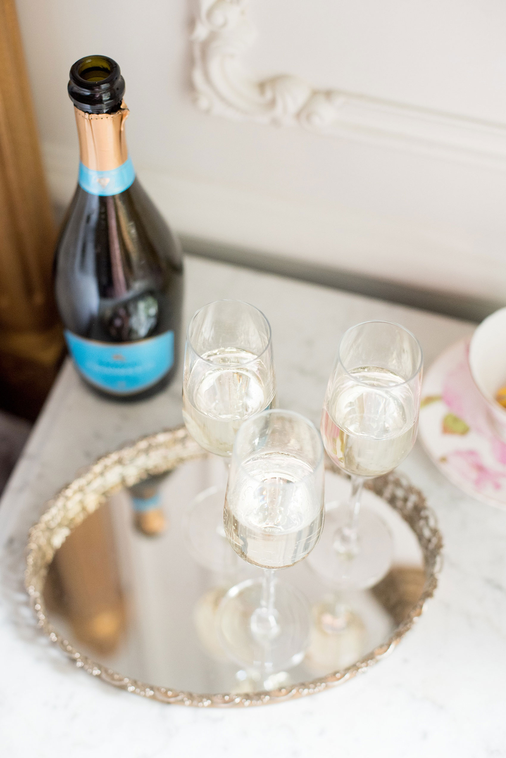 Mikkel Paige Photography captures a luxury wedding in NYC. The bridal party prepares at The Marlton Hotel with champagne.