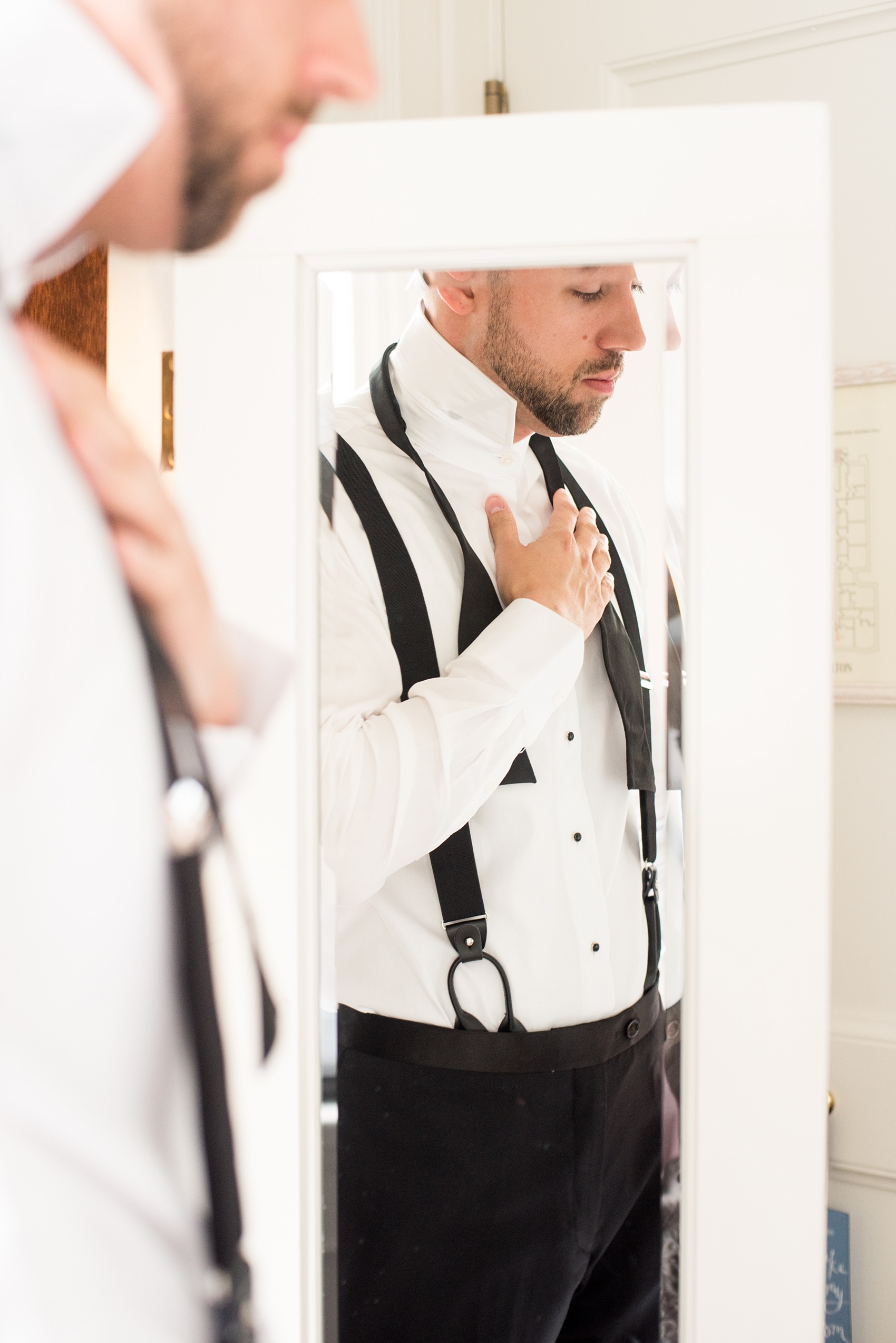 Mikkel Paige Photography photos of a luxury wedding in NYC. Image of the groom getting ready at The Marlton Hotel.