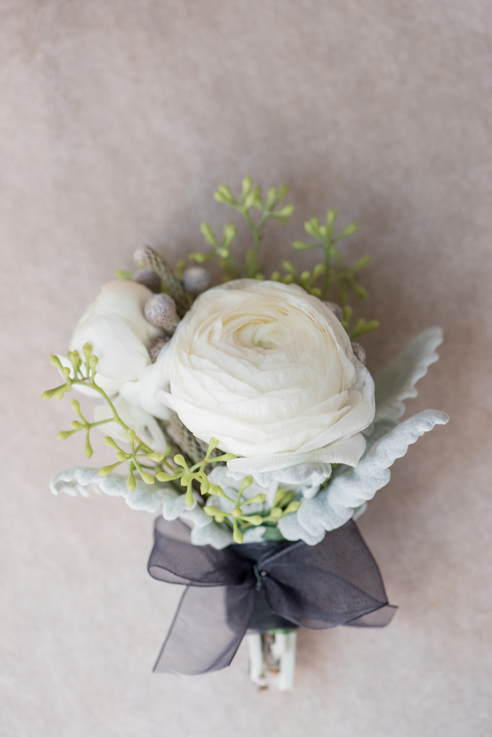 Mikkel Paige Photography photos of a luxury wedding in NYC. Image of the groom's white ranunculus boutonniere.