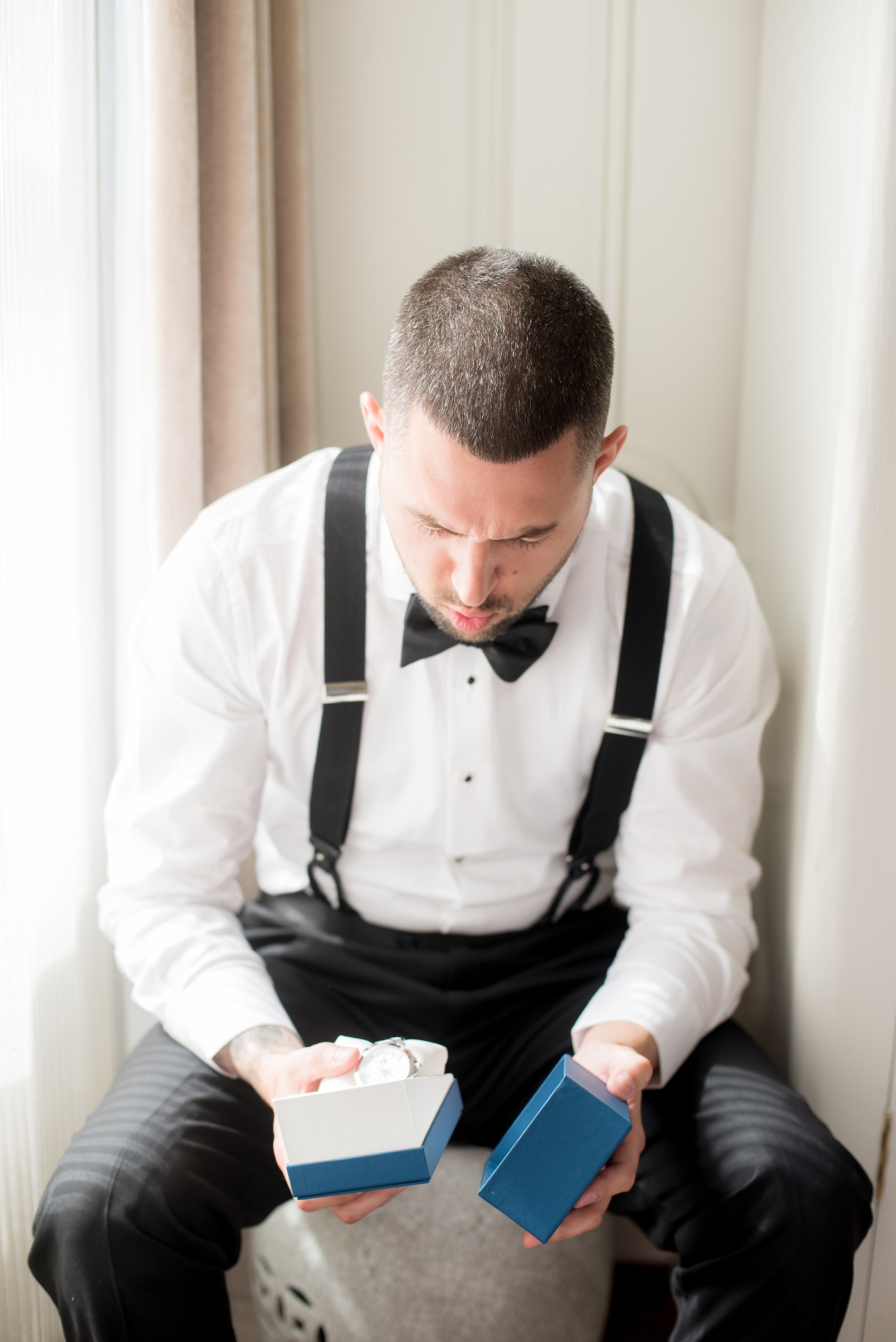 Mikkel Paige Photography photos of a luxury wedding in NYC. Image of the groom getting ready at The Marlton Hotel.