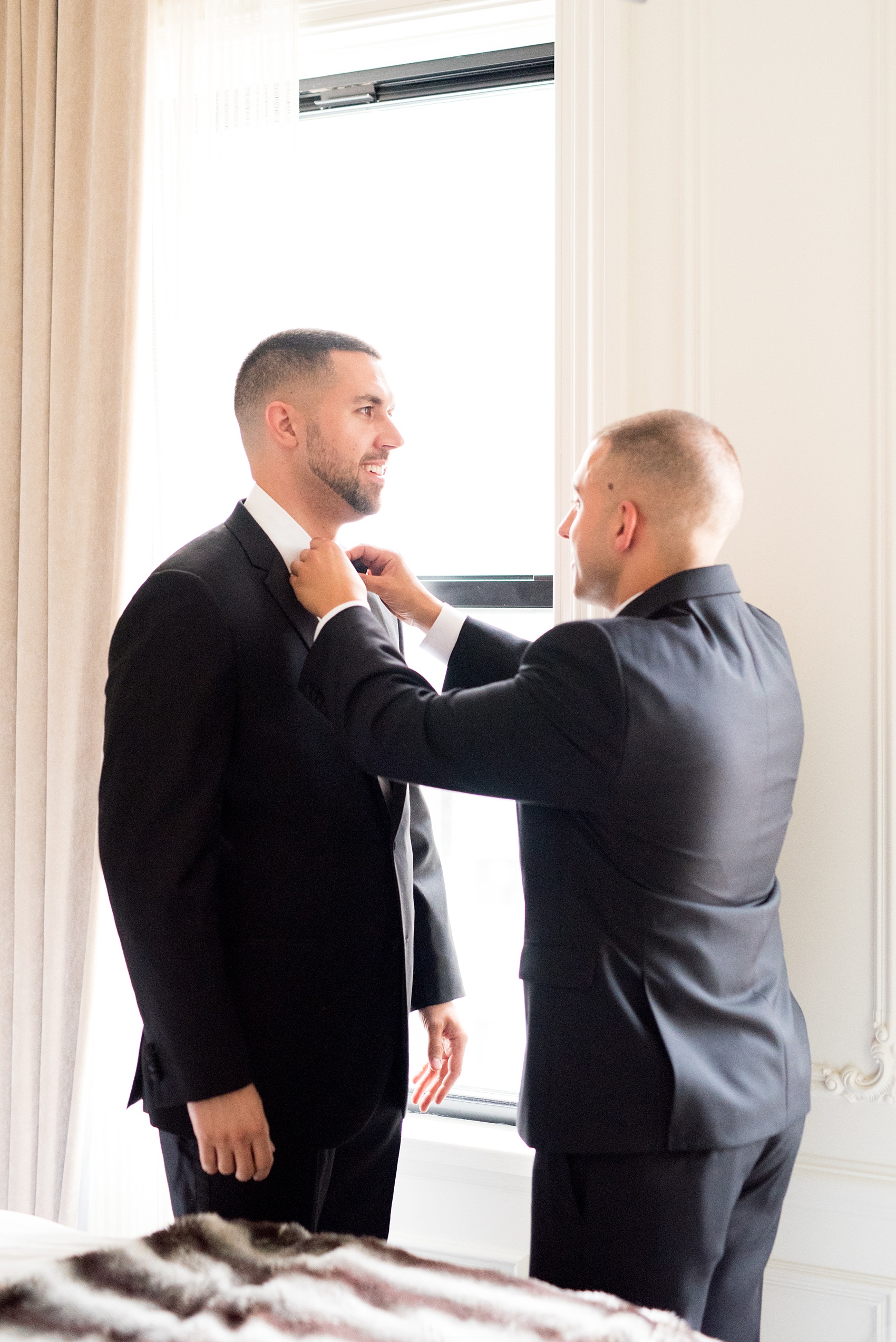 Mikkel Paige Photography photos of a luxury wedding in NYC. Image of the groom getting ready with his brother and best man at The Marlton Hotel.