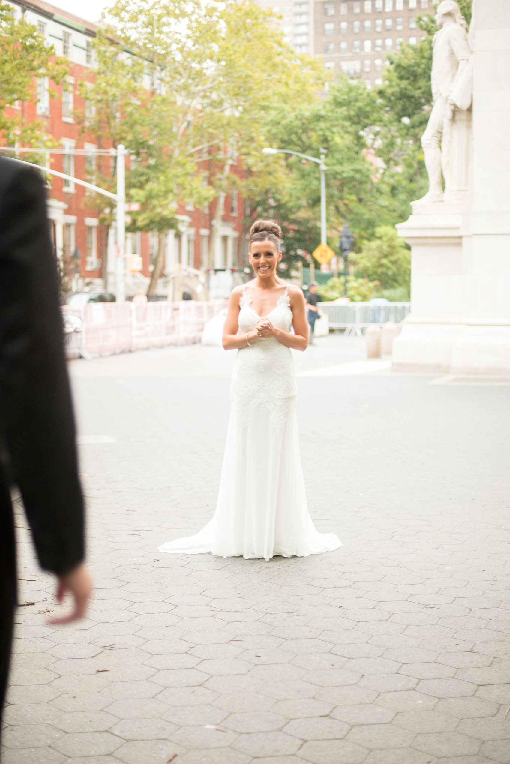 Mikkel Paige Photography photos of a luxury wedding in NYC. First look in Washington Square Park with a picture of the bride in her form fitting David Fielden wedding gown from Kleinfeld's.