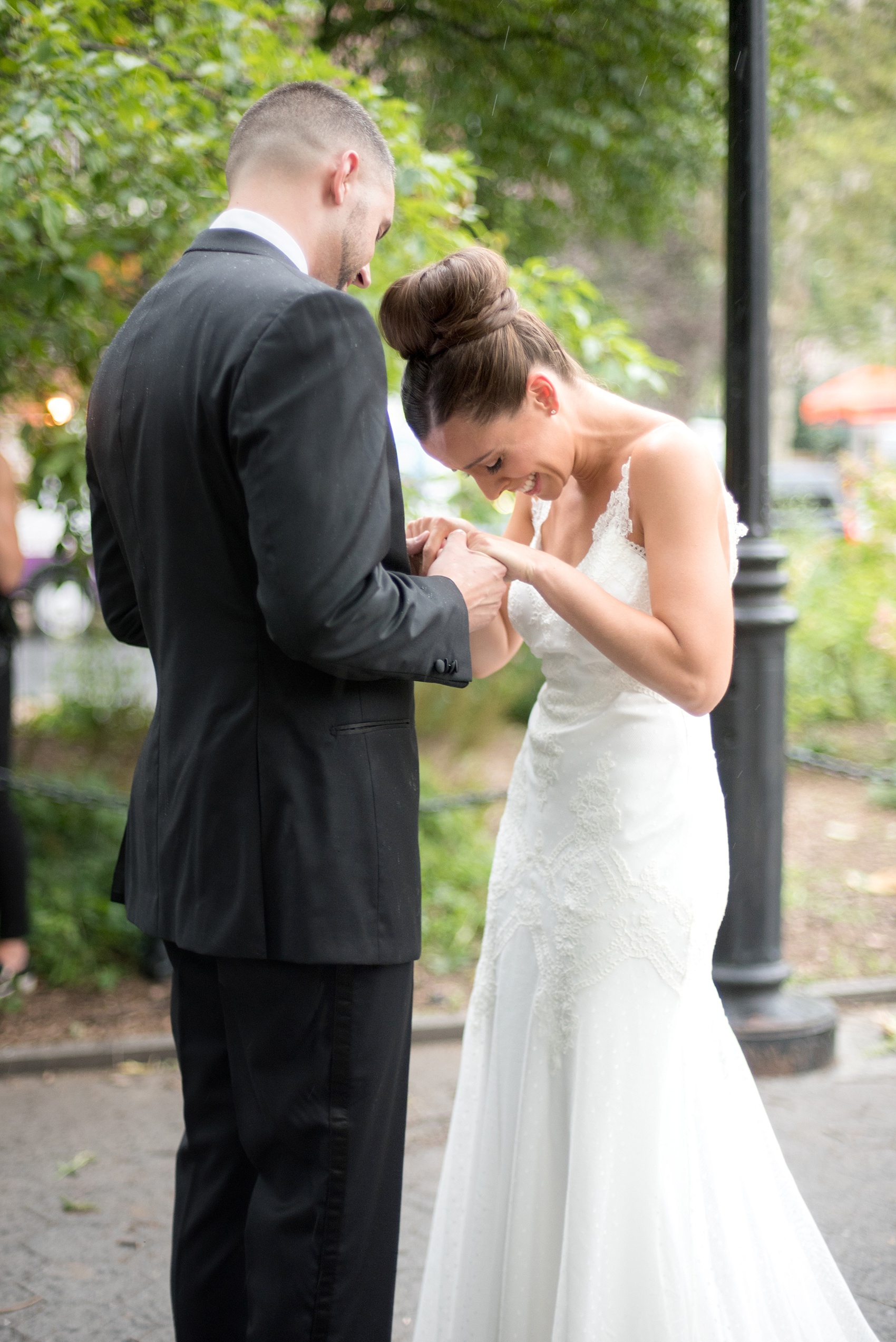 Mikkel Paige Photography photos of a luxury wedding in NYC. First look in Washington Square Park with a picture of the bride in her form fitting David Fielden wedding gown from Kleinfeld's.