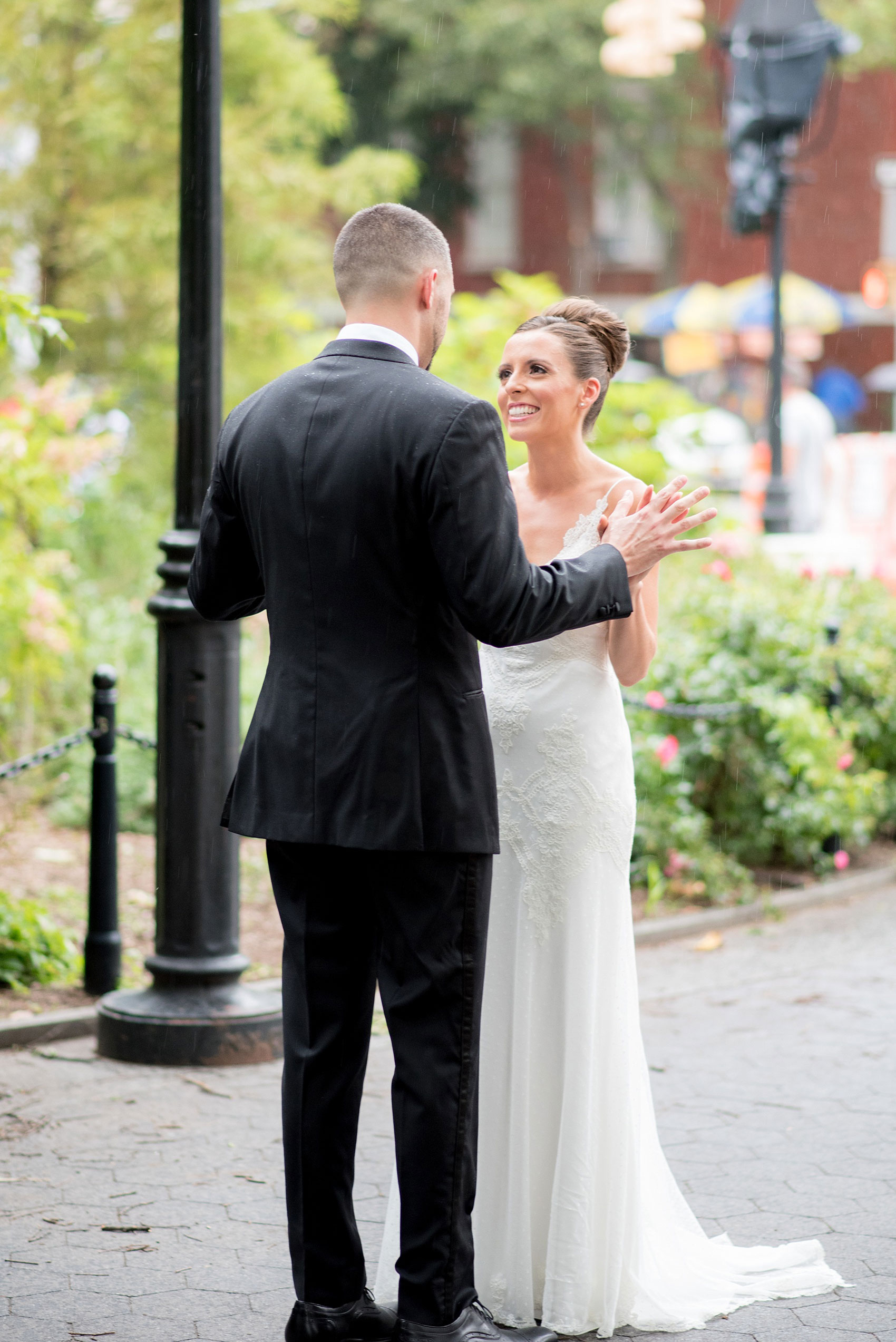 Mikkel Paige Photography photos of a luxury wedding in NYC. First look in Washington Square Park with a picture of the bride in her form fitting David Fielden wedding gown from Kleinfeld's.