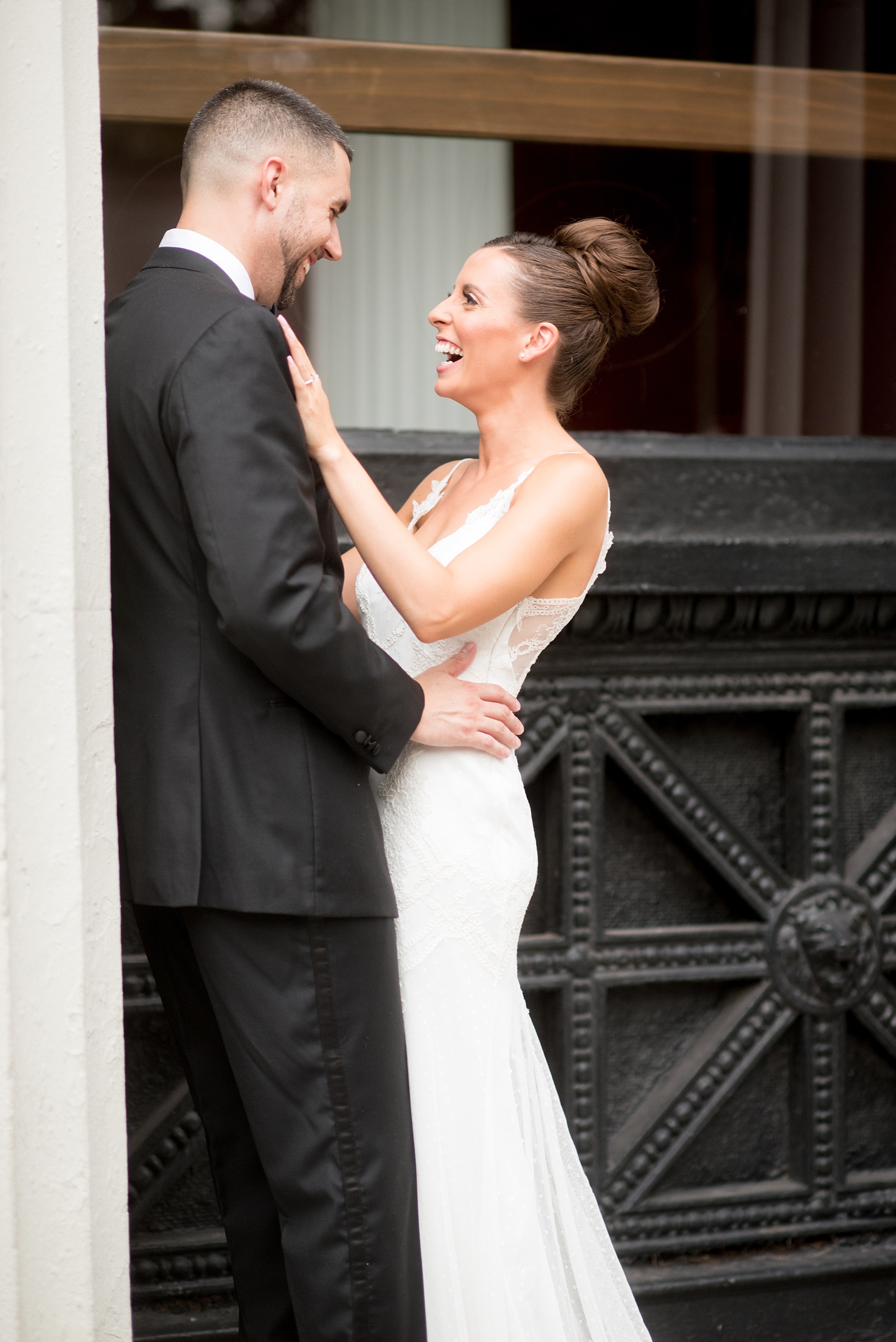 Mikkel Paige Photography photos of a luxury wedding in NYC. Image of the bride and groom near Washington Square Park between white columns.