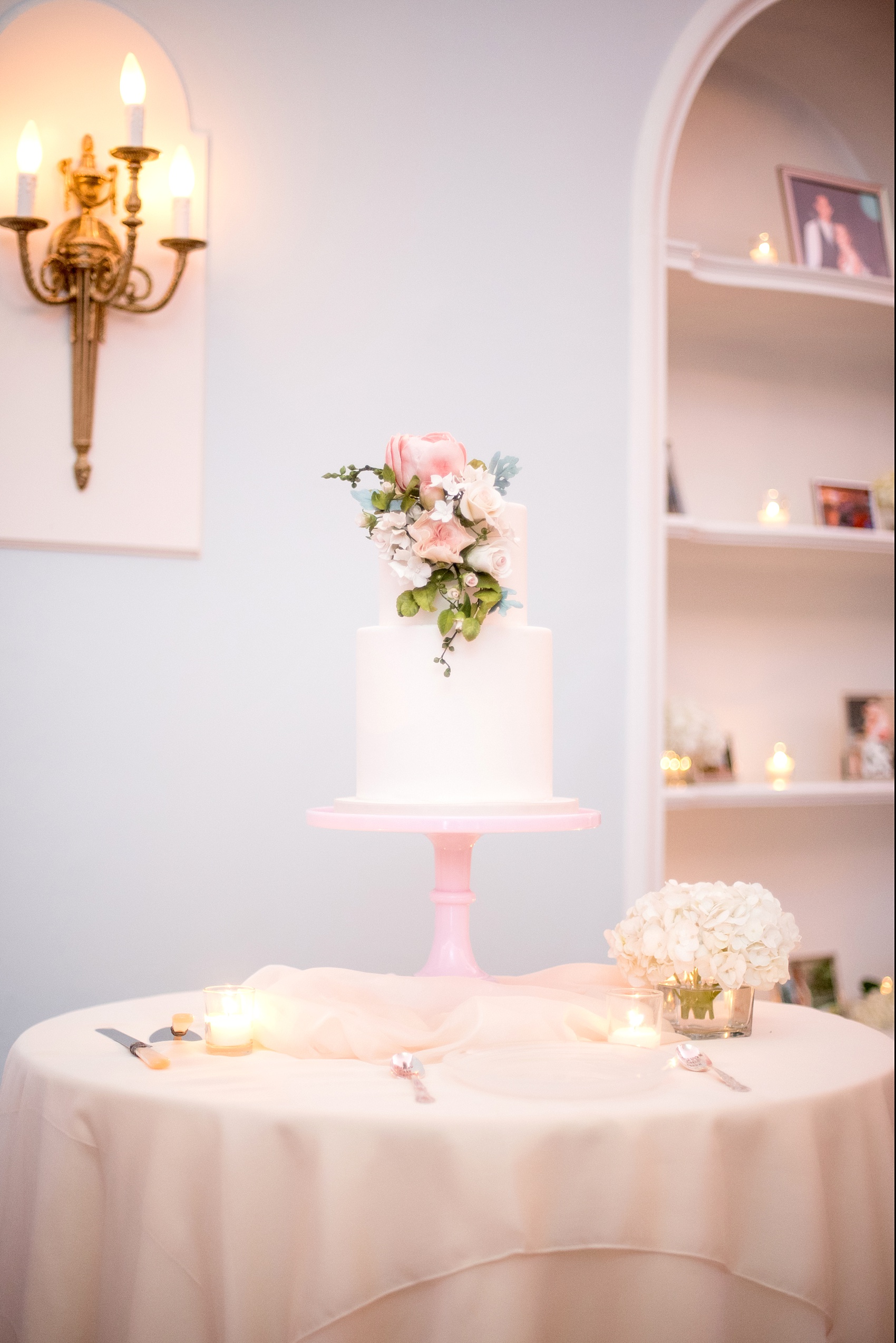 Mikkel Paige Photography photos of a luxury wedding in NYC. Image of India House reception and elegant white tiered cake with gumpaste flowers by Madison Lee.