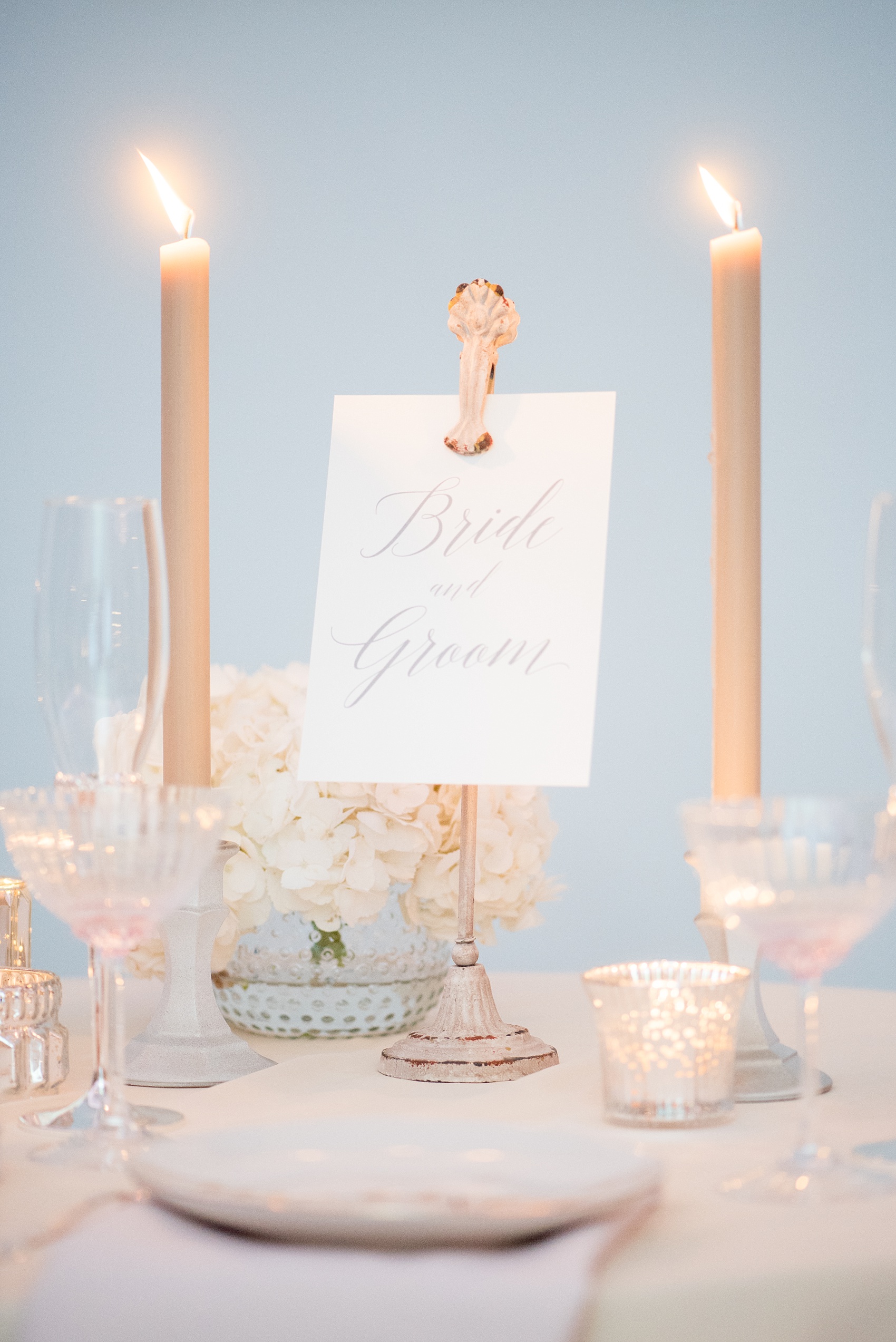 Mikkel Paige Photography photos of a luxury wedding in NYC. Image of the India House reception sweetheart table in lower Manhattan with a custom calligraphy Bride and Groom sign.