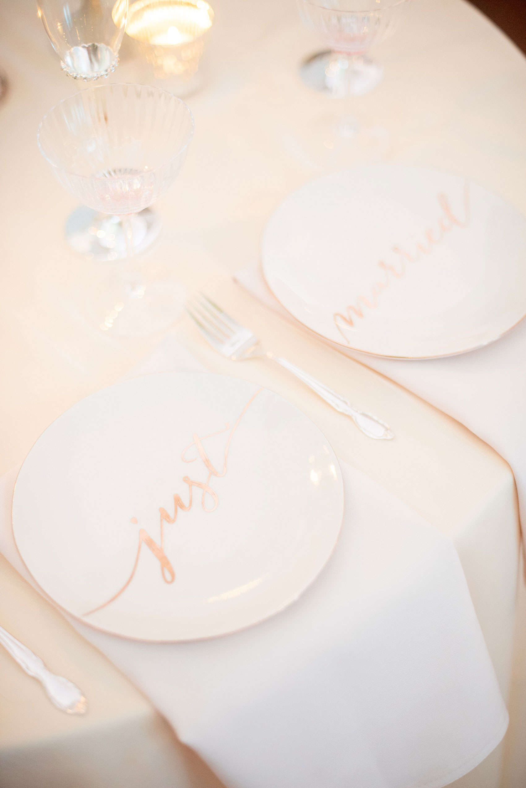 Mikkel Paige Photography photos of a luxury wedding in NYC. Image of the India House reception sweetheart table in lower Manhattan with two "just married" plates.