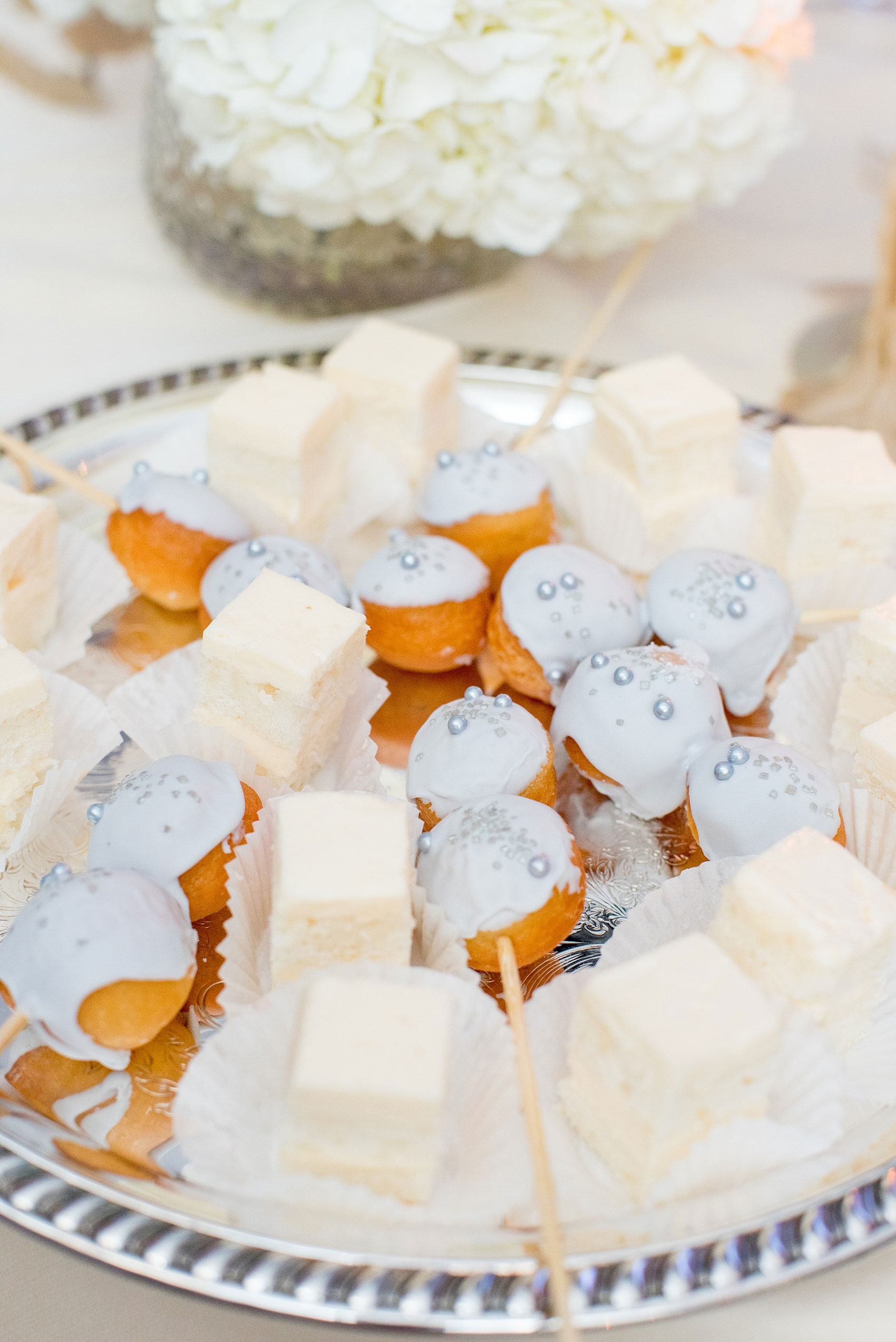 Mikkel Paige Photography photos of a luxury wedding in NYC. Photo of plated donut holes and cake for an India House reception in Manhattan.