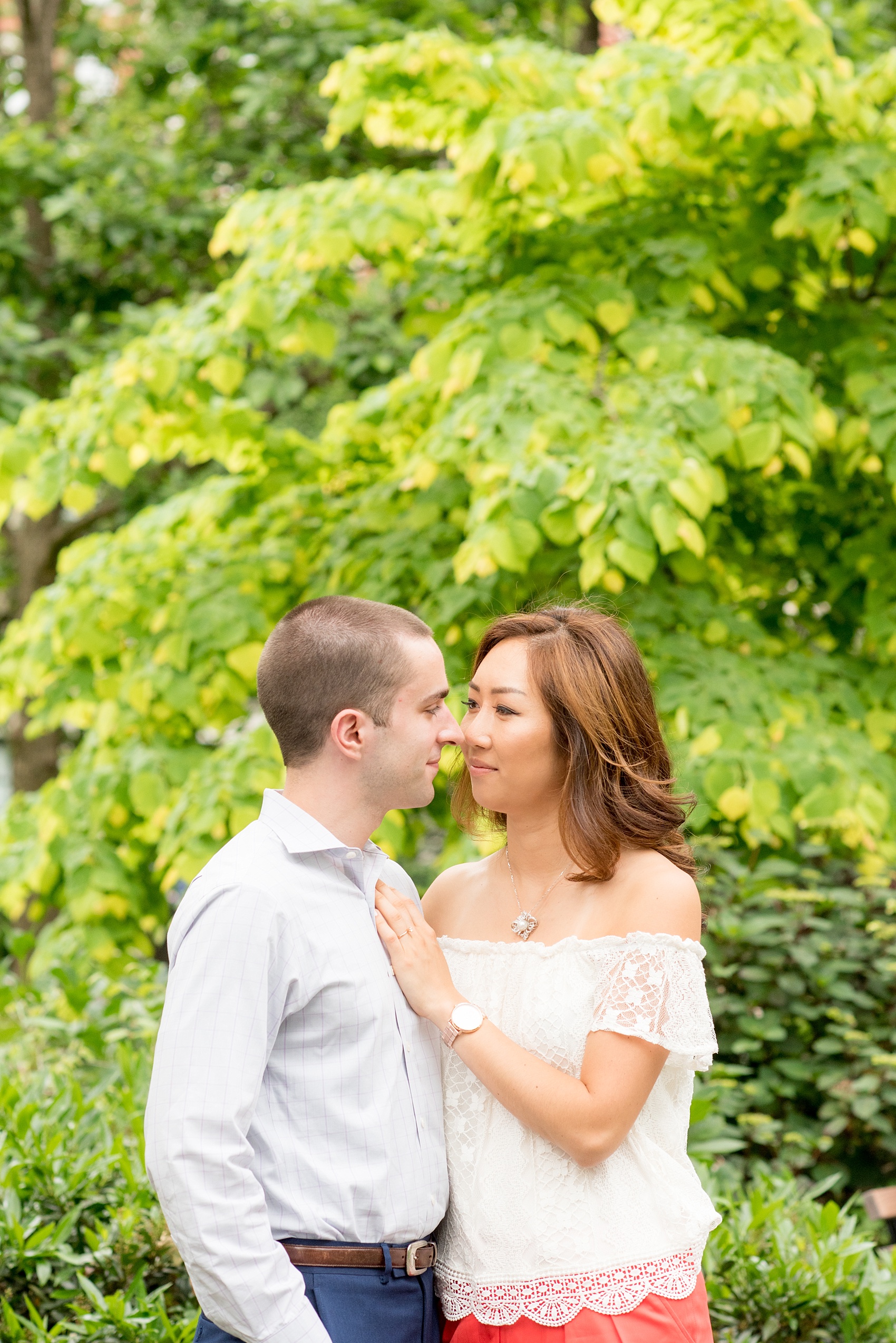Mikkel Paige Photography photos of a Madison Square Park engagement session in NYC during spring. The bride wore an off-the-shoulder white lace top.