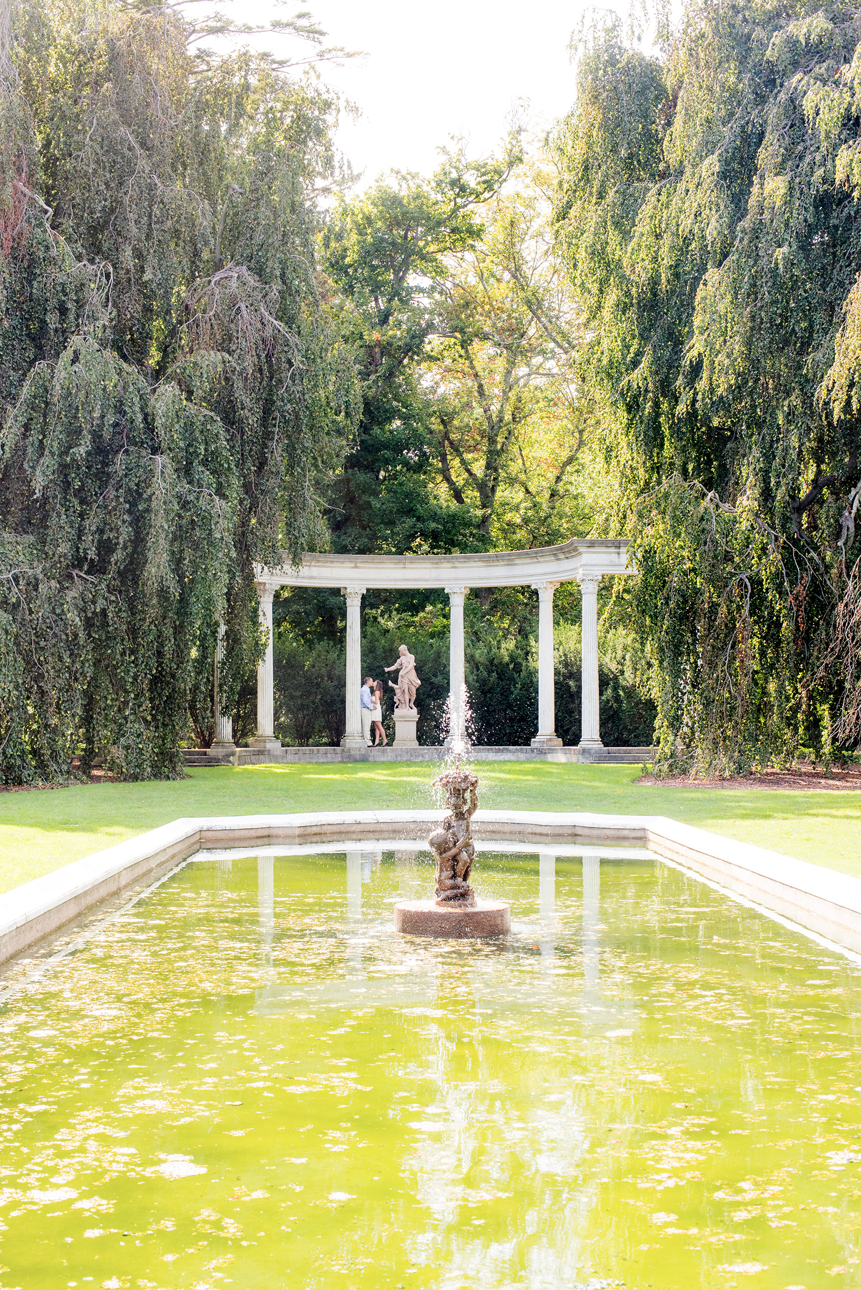 Mikkel Paige Photography photo of an Old Westbury Gardens wedding summer engagement session on Long Island. Image of iconic columns and reflecting pond and fountain.