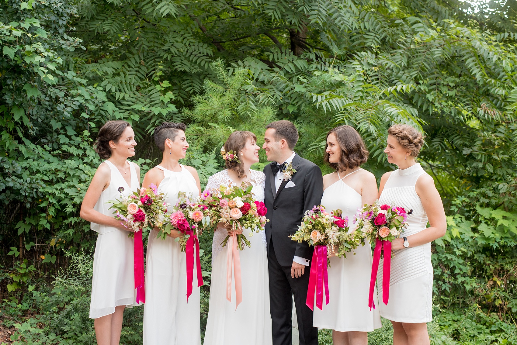 Mikkel Paige Photography photos from a wedding at Prospect Park Boathouse in Brooklyn, NY. Bride in a Reem Acra gown and bridesmaids in white with bouquets tied with pink ribbon by Sachi Rose.