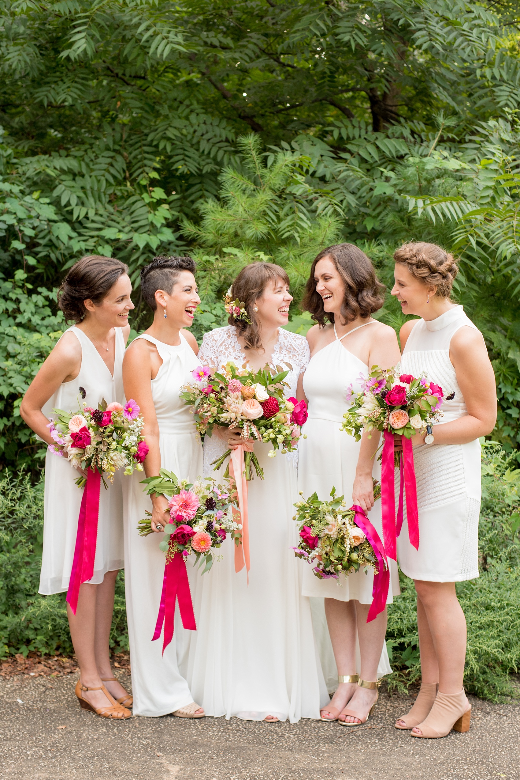 Mikkel Paige Photography photos from a wedding at Prospect Park Boathouse in Brooklyn, NY. Bride in a Reem Acra gown and bridesmaids in white with bouquets tied with pink ribbon by Sachi Rose.