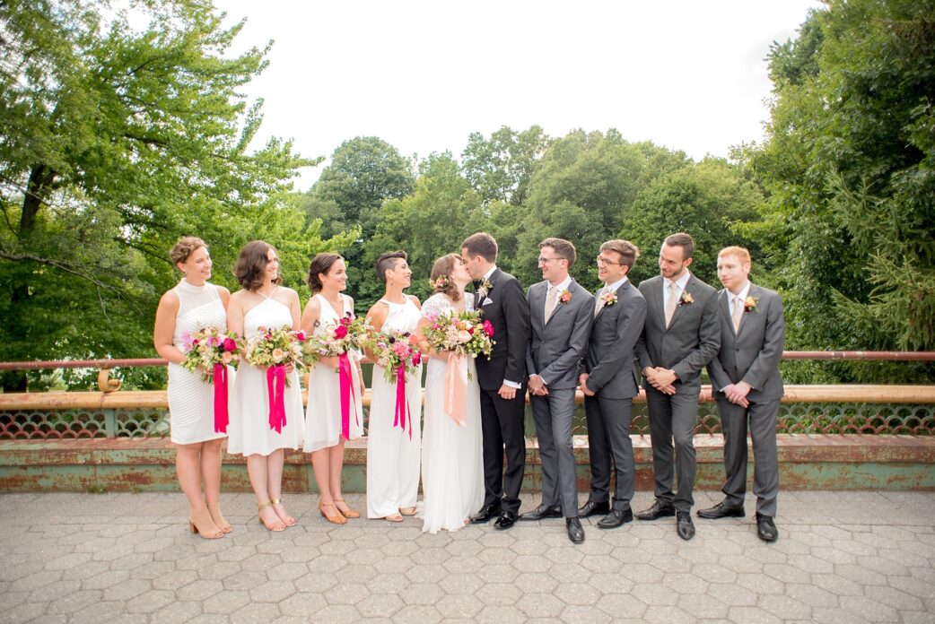 Mikkel Paige Photography photos from a wedding at Prospect Park Boathouse in Brooklyn, NY. Bride in a Reem Acra gown and bridesmaids in white with bouquets tied with pink ribbon by Sachi Rose.