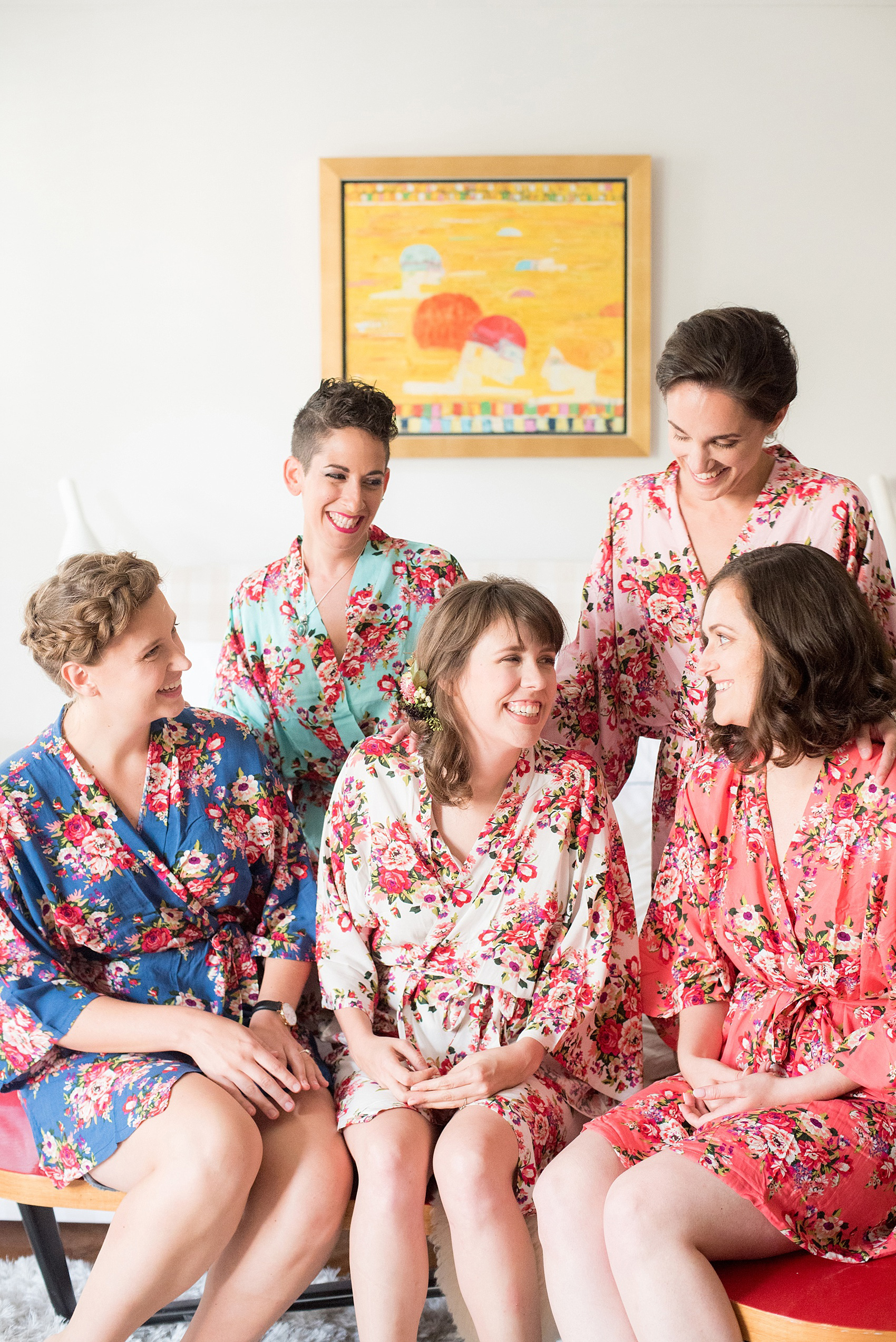 Mikkel Paige Photography photos of a wedding at Prospect Park Boathouse in Brooklyn, NY. The bride and her bridesmaids prepared in floral robes in colorful patterns.