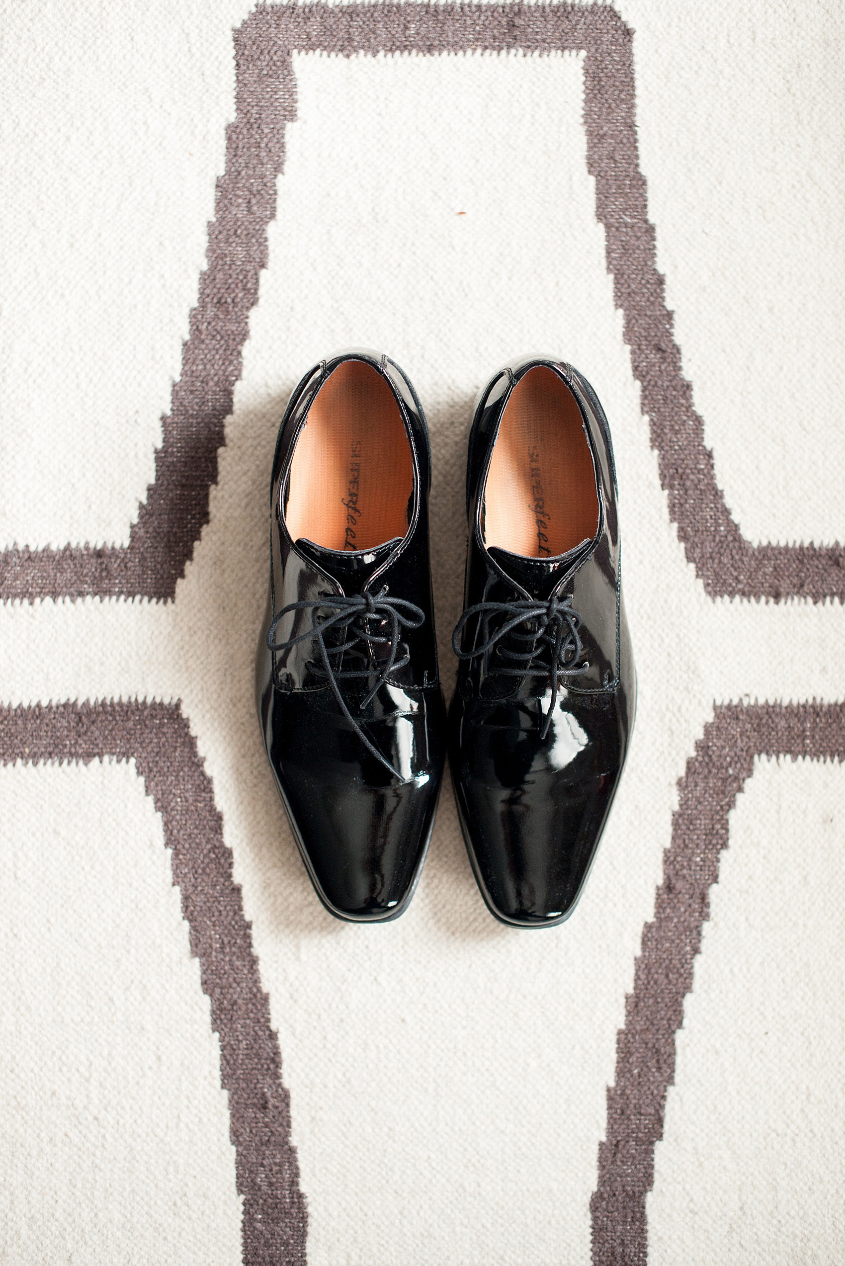 Mikkel Paige Photography photos of a wedding at Prospect Park Boathouse in Brooklyn, NY. A photo of the groom's classic black shoes.