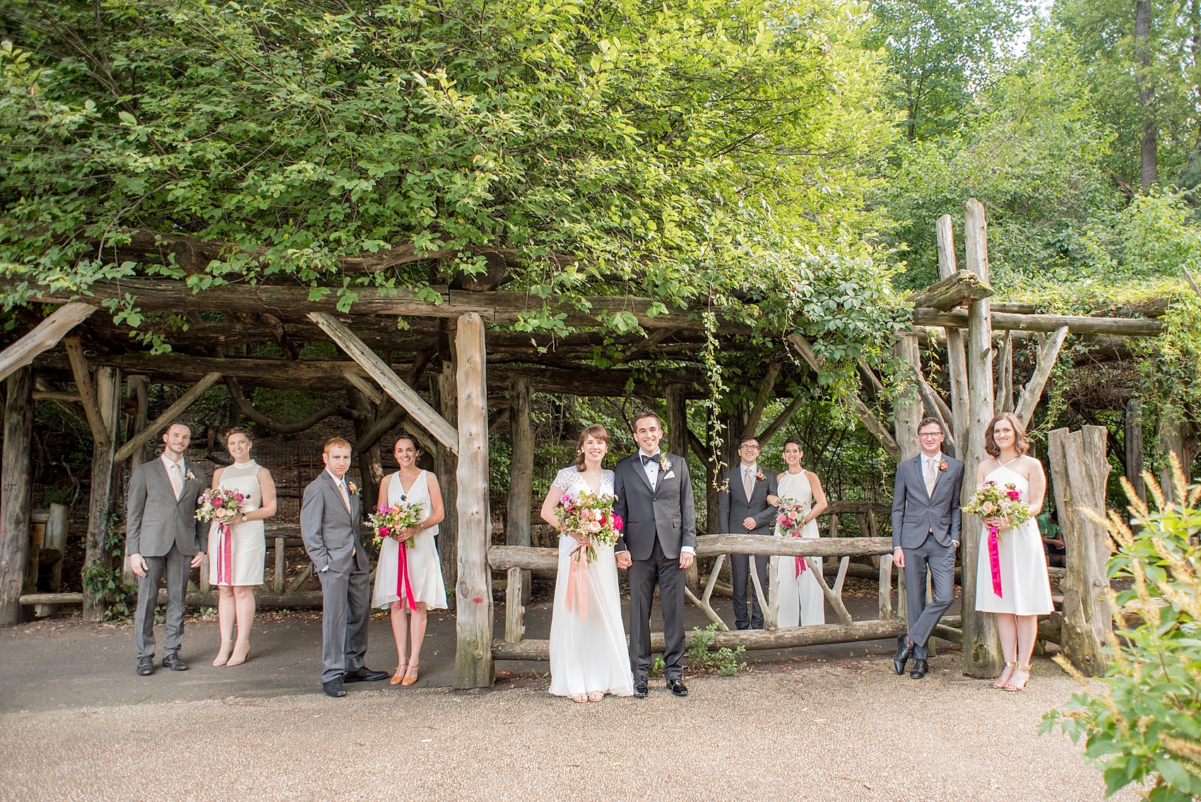 Mikkel Paige Photography photos of a wedding at Prospect Park Boathouse in Brooklyn, NY. Vogue-like photo of the all-white bridal party and groomsmen in grey suits. The bride wore Reem Acra and groom a classic black tuxedo.