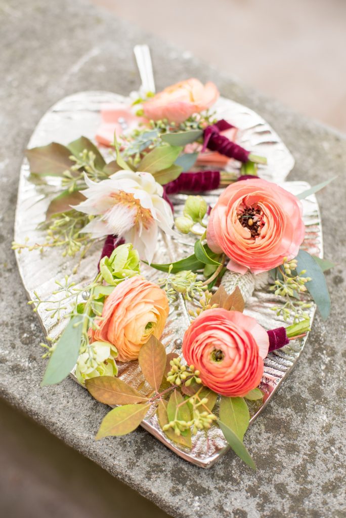Mikkel Paige Photography photo of boutonnieres for a Prospect Park Boathouse wedding in Brooklyn, New York. Sachi Rose created them out of ranunculus, blushing bride protea and seeded eucalyptus.