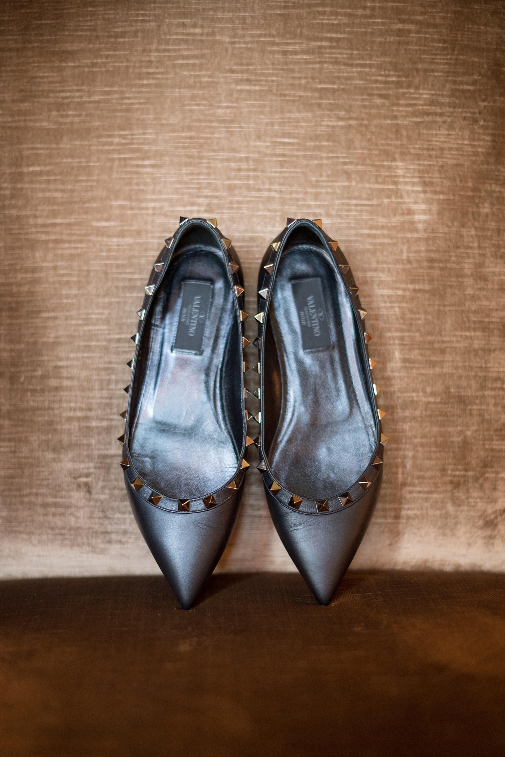 Mikkel Paige Photography photo of the bride's Valentino flats, black with metal studs, for her wedding at Testarossa Winery in Los Gatos, California.