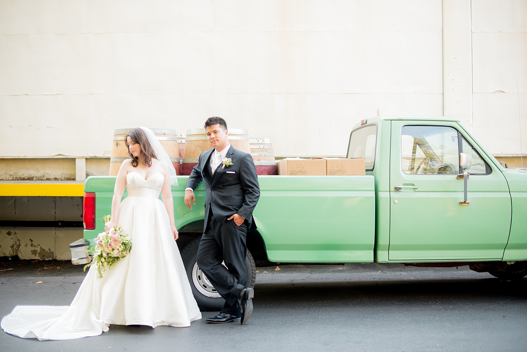 Mikkel Paige Photography photo of the bride and groom at their wedding at Testarossa Winery in Los Gatos, California with a vintage mint green pickup truck.