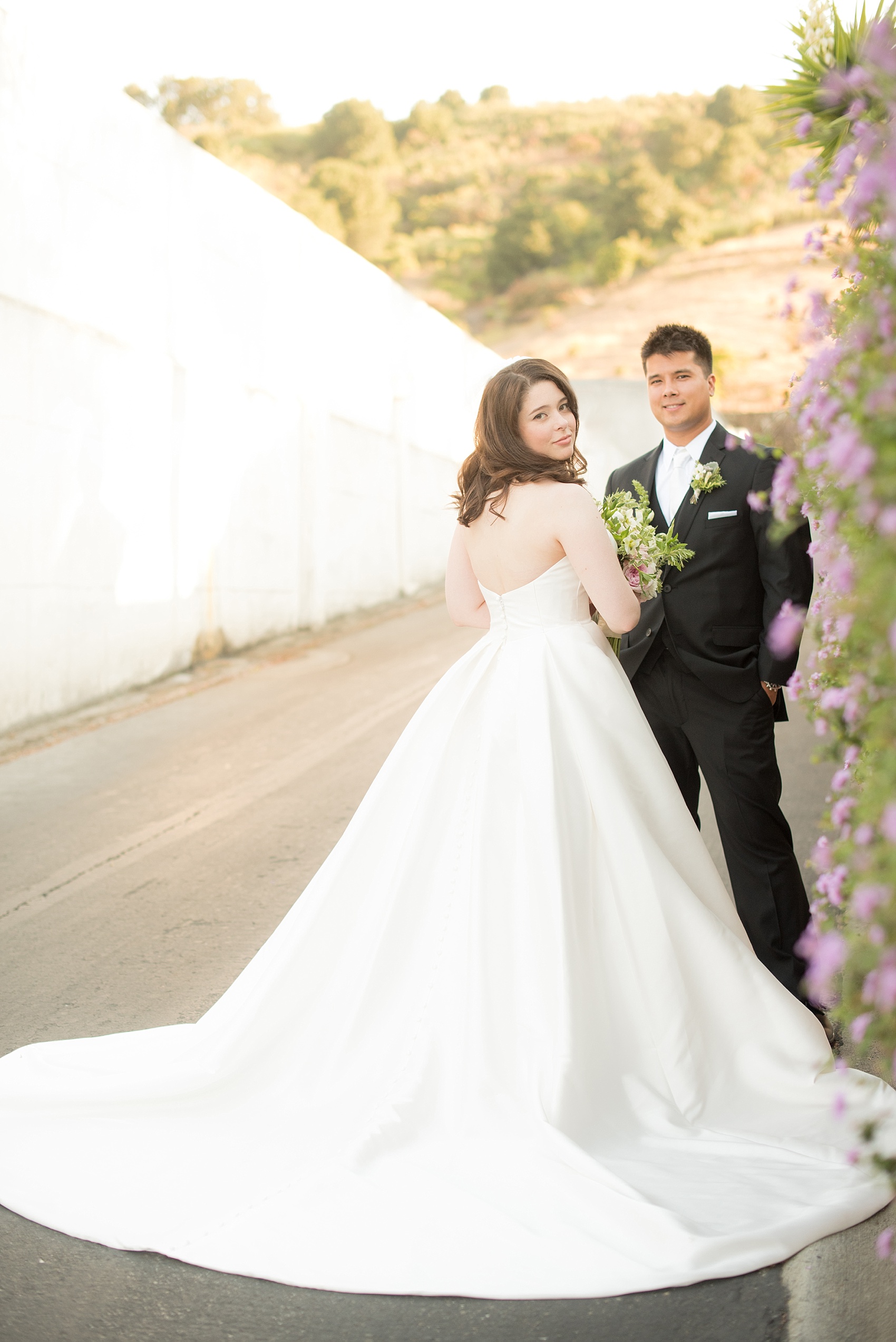 Mikkel Paige Photography photo of the bride and groom at their wedding at Testarossa Winery in Los Gatos, California with an Essence of Australia gown.