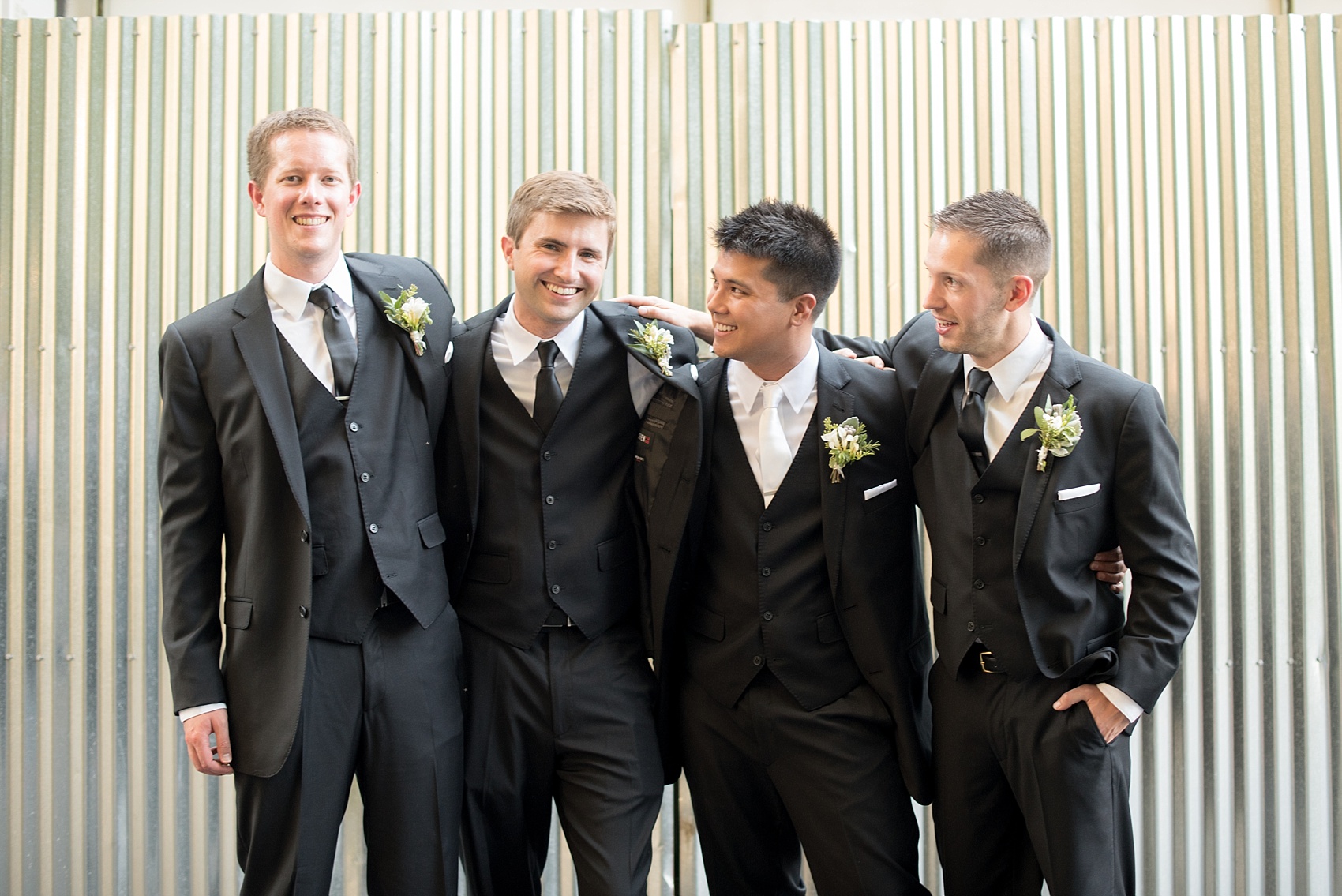 Mikkel Paige Photography photo of the groom and his groomsmen in front of an urban backdrop at his wedding at Testarossa Winery in Los Gatos, California.