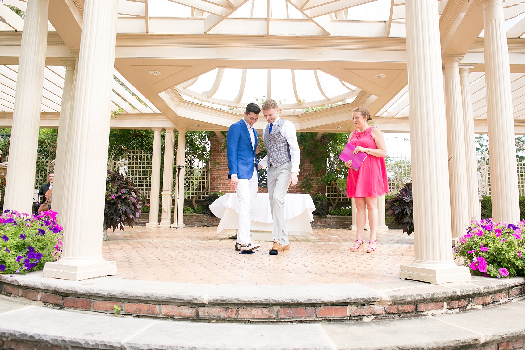 Mikkel Paige Photography photos of a gay wedding at The Manor in West Orange, NJ. Image of grooms stepping on the glass during their outdoor ceremony.