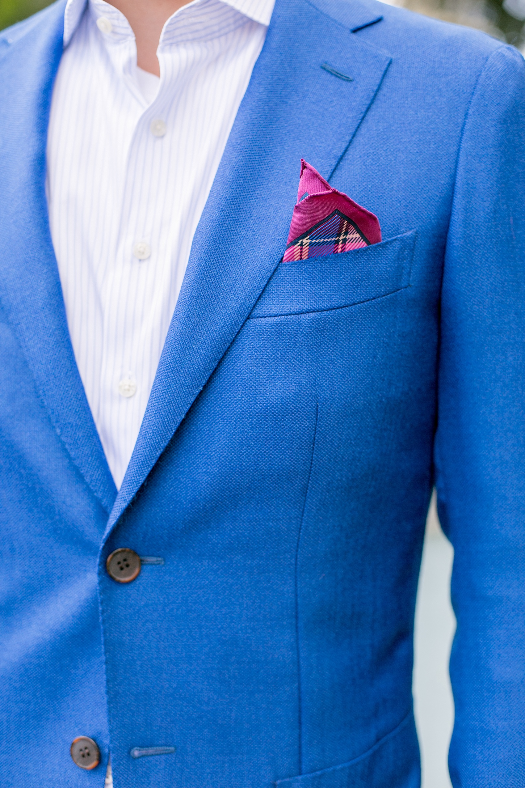 Mikkel Paige Photography photos of a summer, daytime gay wedding. An image of the groom in a blue suit with pink pocket square at The Manor, in West Orange New Jersey.