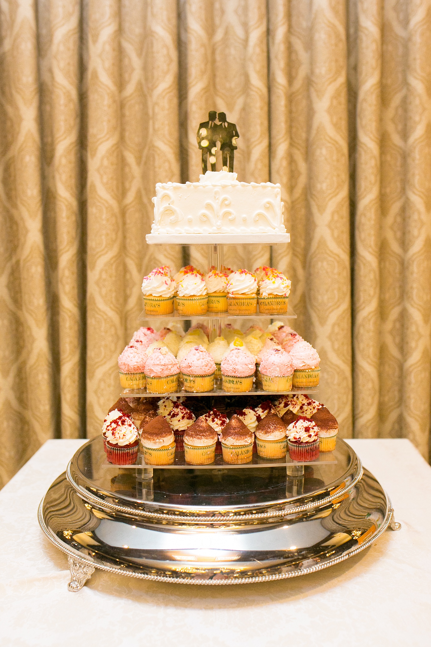 Mikkel Paige Photography photos of a gay wedding at The Manor in West Orange, NJ. The grooms chose a cupcake tower for a cake cutting.