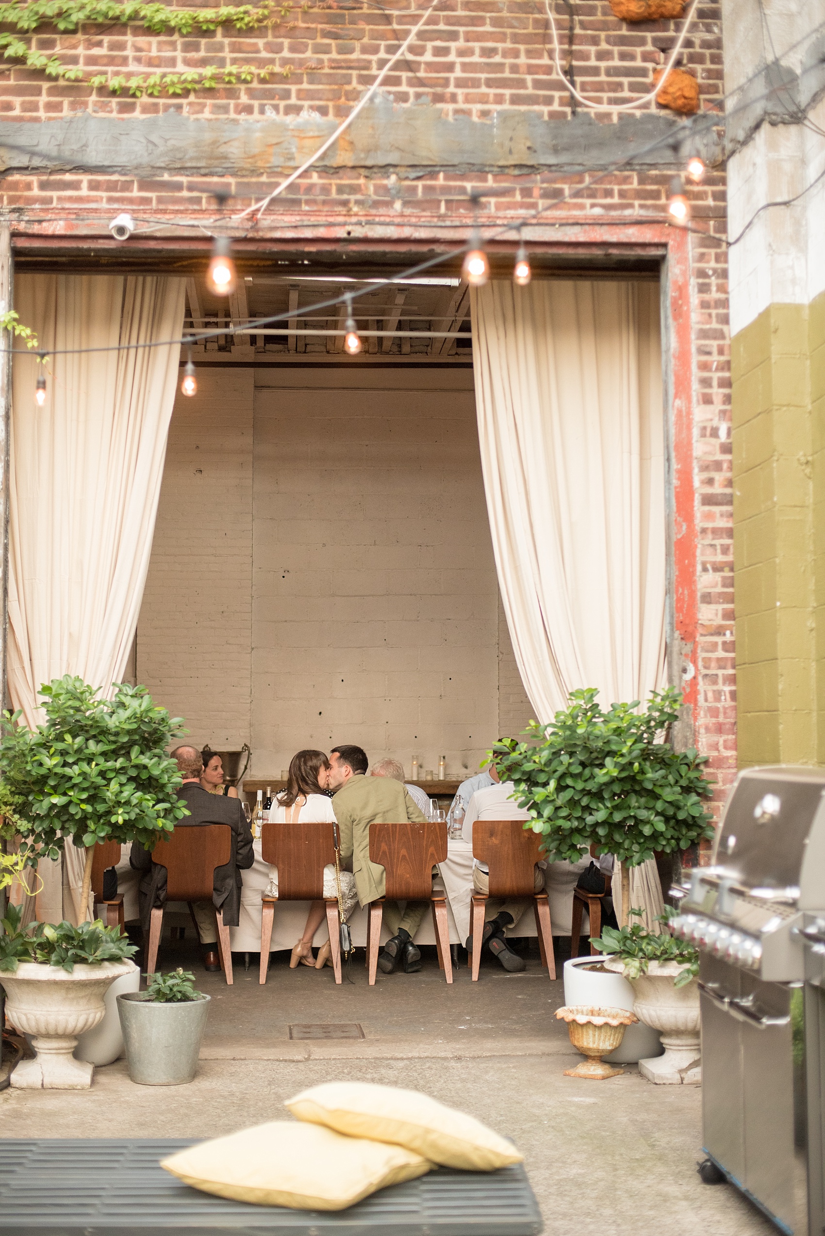 Mikkel Paige Photography photos of a wedding rehearsal dinner at Aterlier Roquette, Brooklyn. A romantic intimate setting for a small gathering in a warehouse district with an outside courtyard.