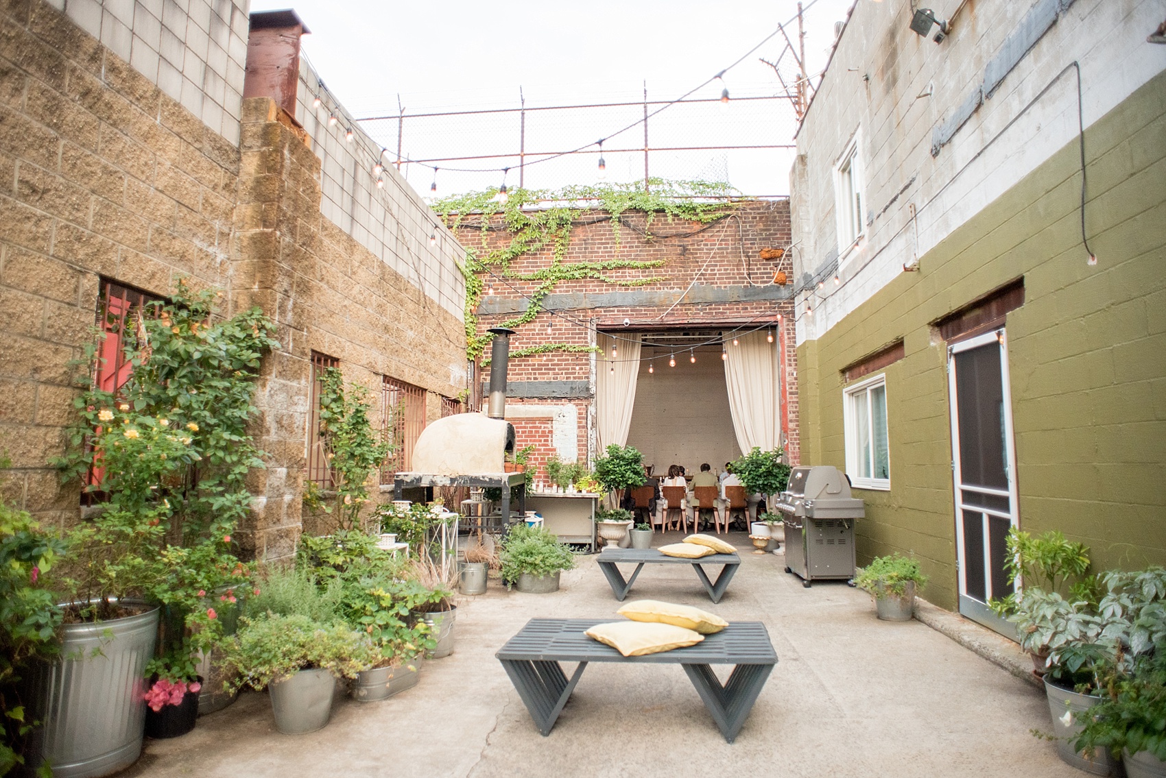 Mikkel Paige Photography photos of a wedding rehearsal dinner at Aterlier Roquette, Brooklyn. A romantic intimate setting for a small gathering in a warehouse district with an outside courtyard and candlelight.