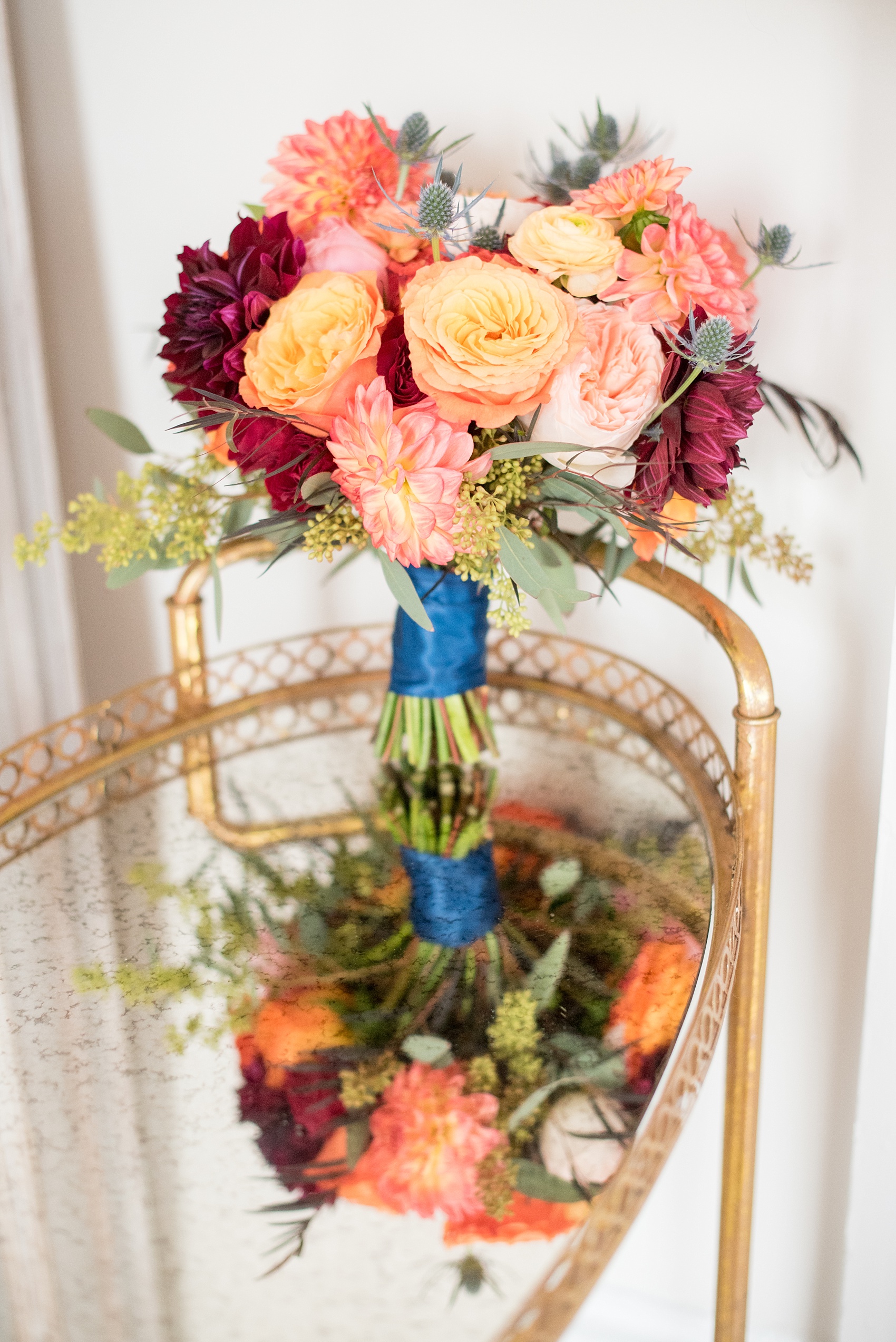 Mikkel Paige Photography pictures from a Merrimon-Wynne House wedding in Raleigh. One of the two brides carried this colorful fall bouquet by Meristem Floral.