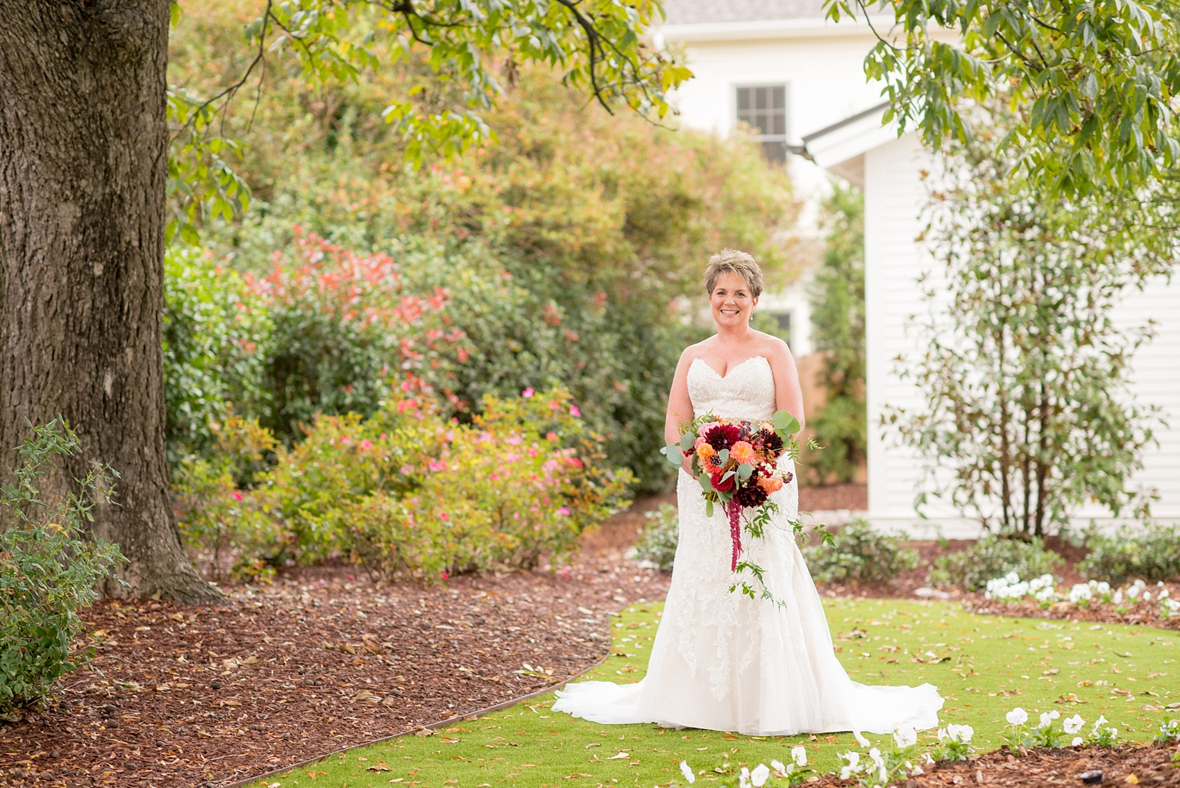 Mikkel Paige Photography photos from a Merrimon-Wynne House wedding in Raleigh. The bride wore a strapless gown and carried a fall whimsical bouquet by Meristem Floral. 