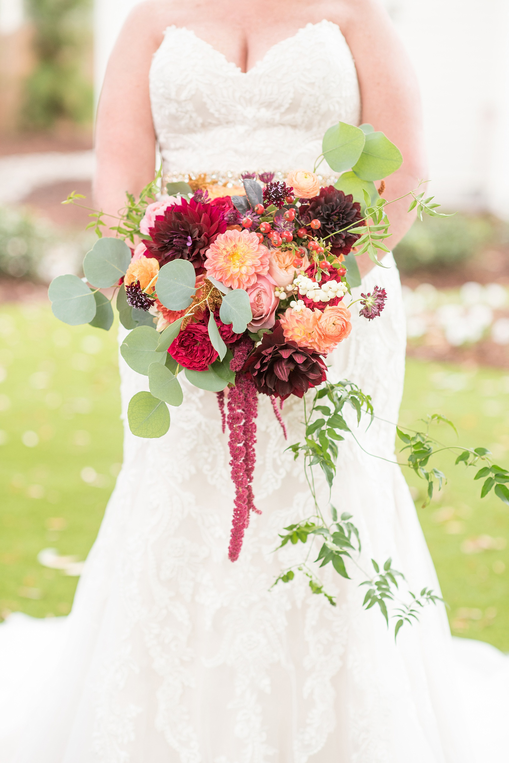 Mikkel Paige Photography photos from a Merrimon-Wynne House wedding in Raleigh. The bride wore a strapless gown and carried a fall whimsical bouquet by Meristem Floral.