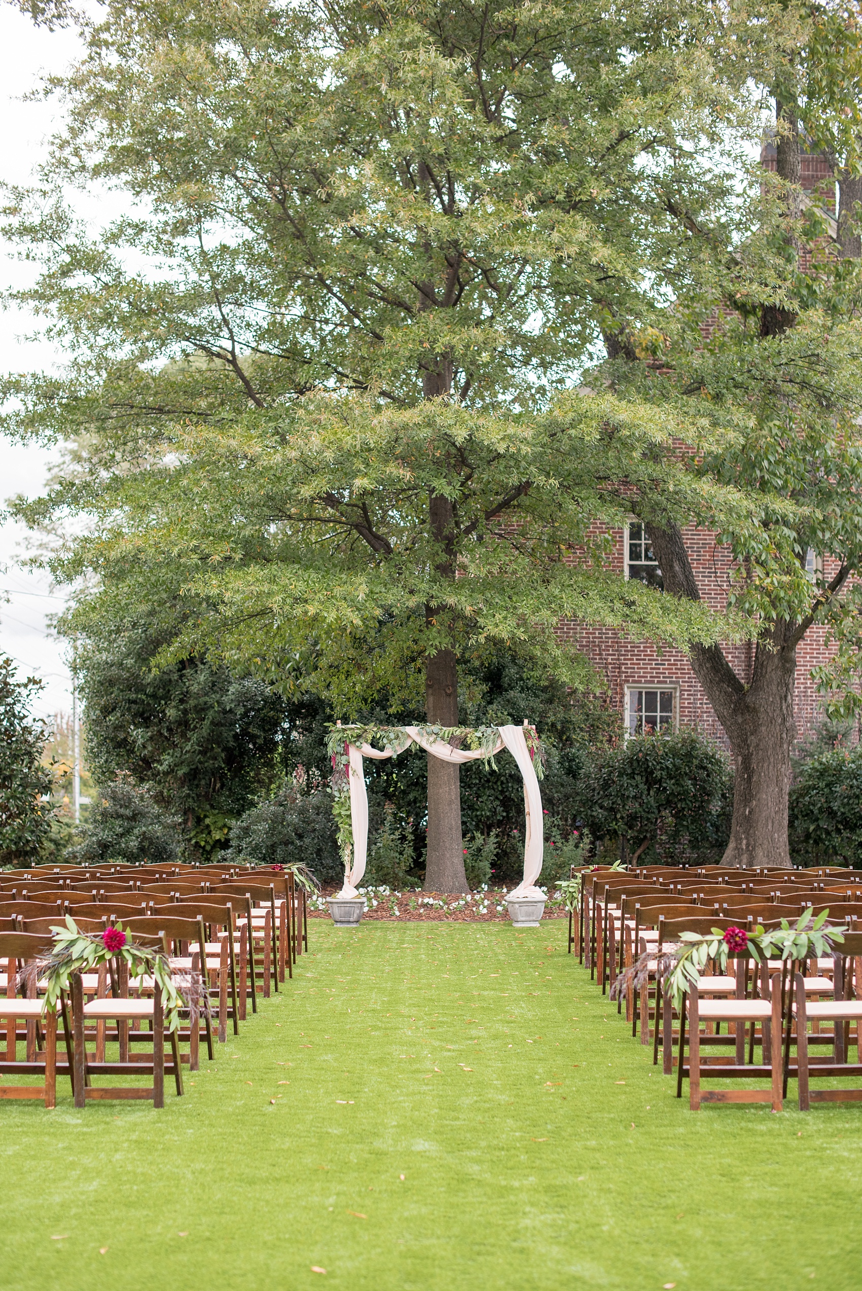 Mikkel Paige Photography photos from a Merrimon-Wynne House wedding in Raleigh. An outdoor ceremony setup with floral altar for a same-sex wedding.