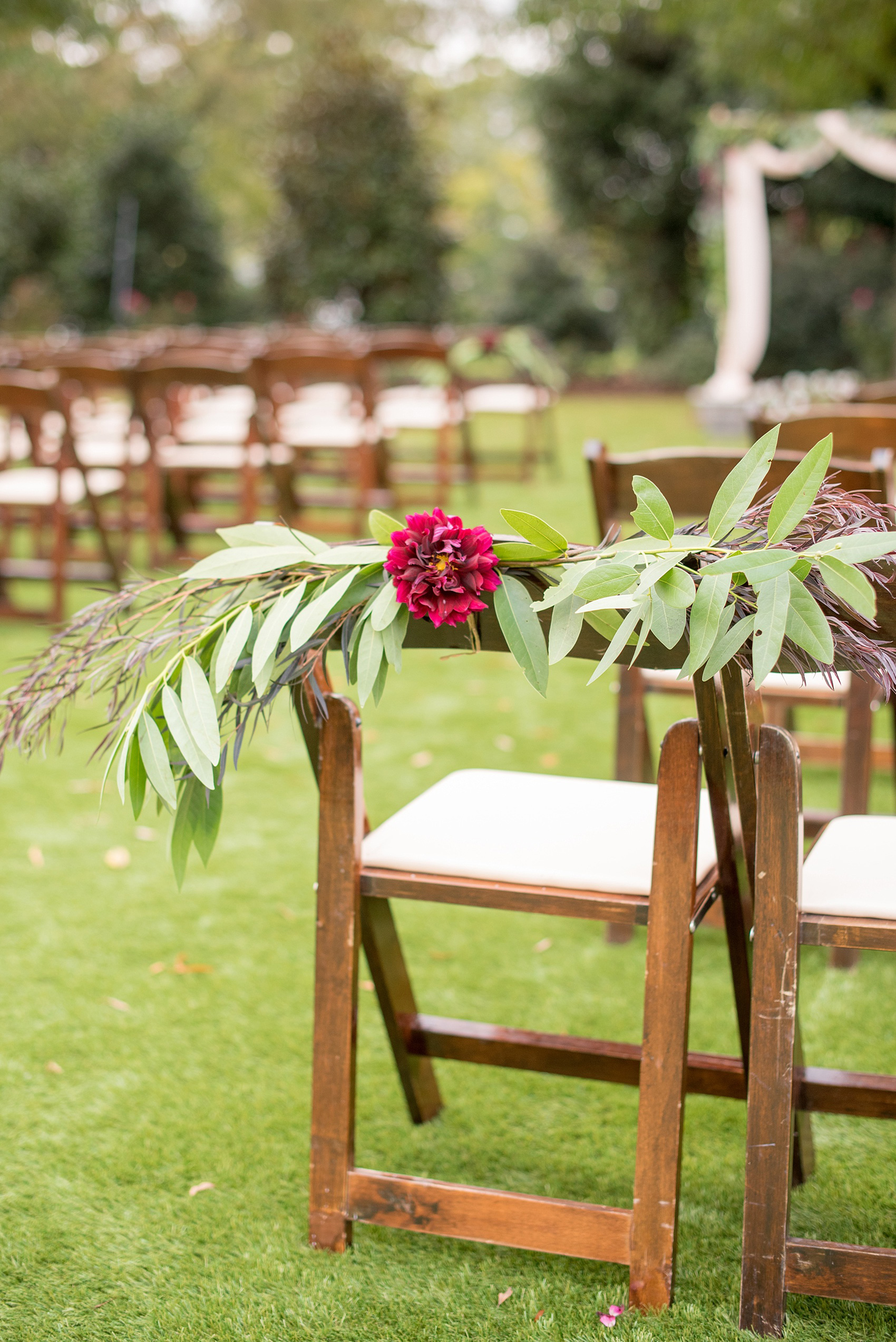 Mikkel Paige Photography photos from a Merrimon-Wynne House wedding in Raleigh. An outdoor ceremony setup with floral chair details for a same-sex autumn wedding.