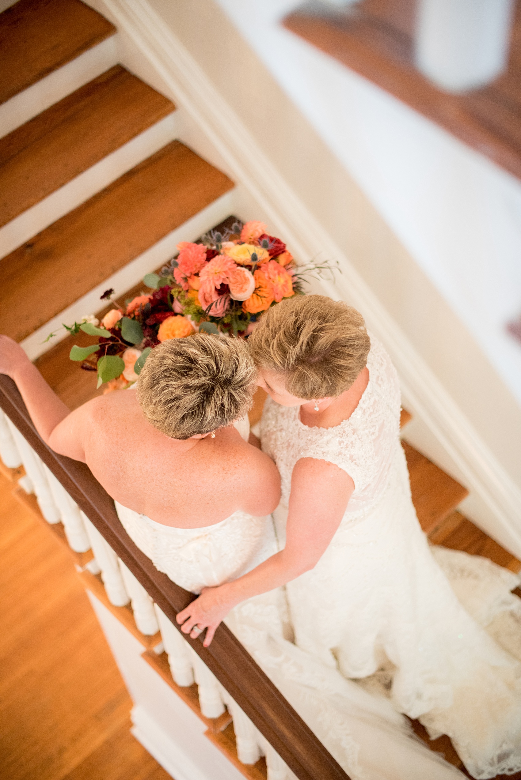 Mikkel Paige Photography photos from a Merrimon-Wynne House wedding in Raleigh. Two brides on a picturesque staircase for a same-sex, lesbian wedding.