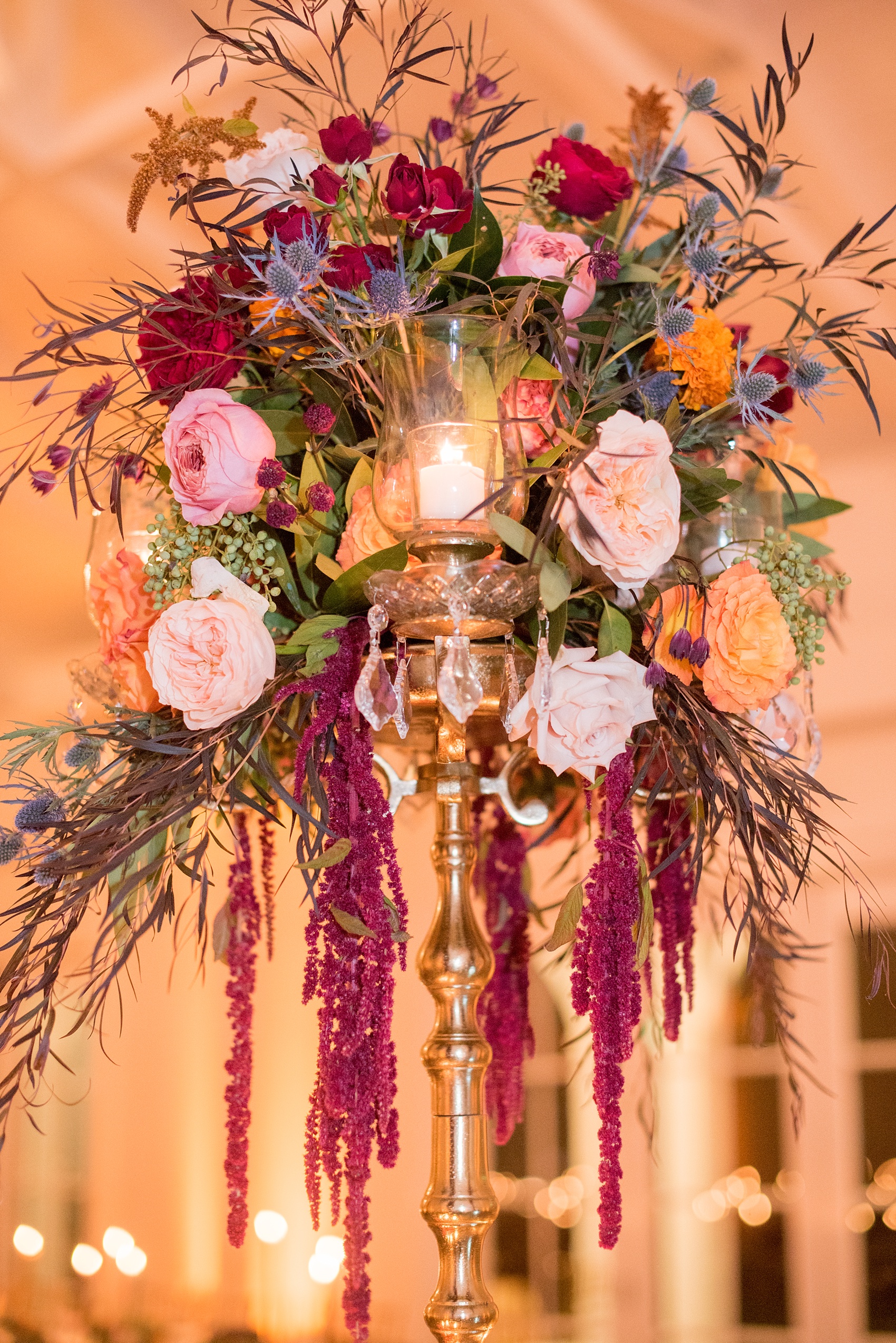 Mikkel Paige Photography photos from a Merrimon-Wynne House wedding in Raleigh. The reception was drenched in romantic candlelight, inside the Carriage House. The sweetheart table candelabra for the brides at this same-sex gay wedding was created with using fall flowers and candles by Meristem Floral.