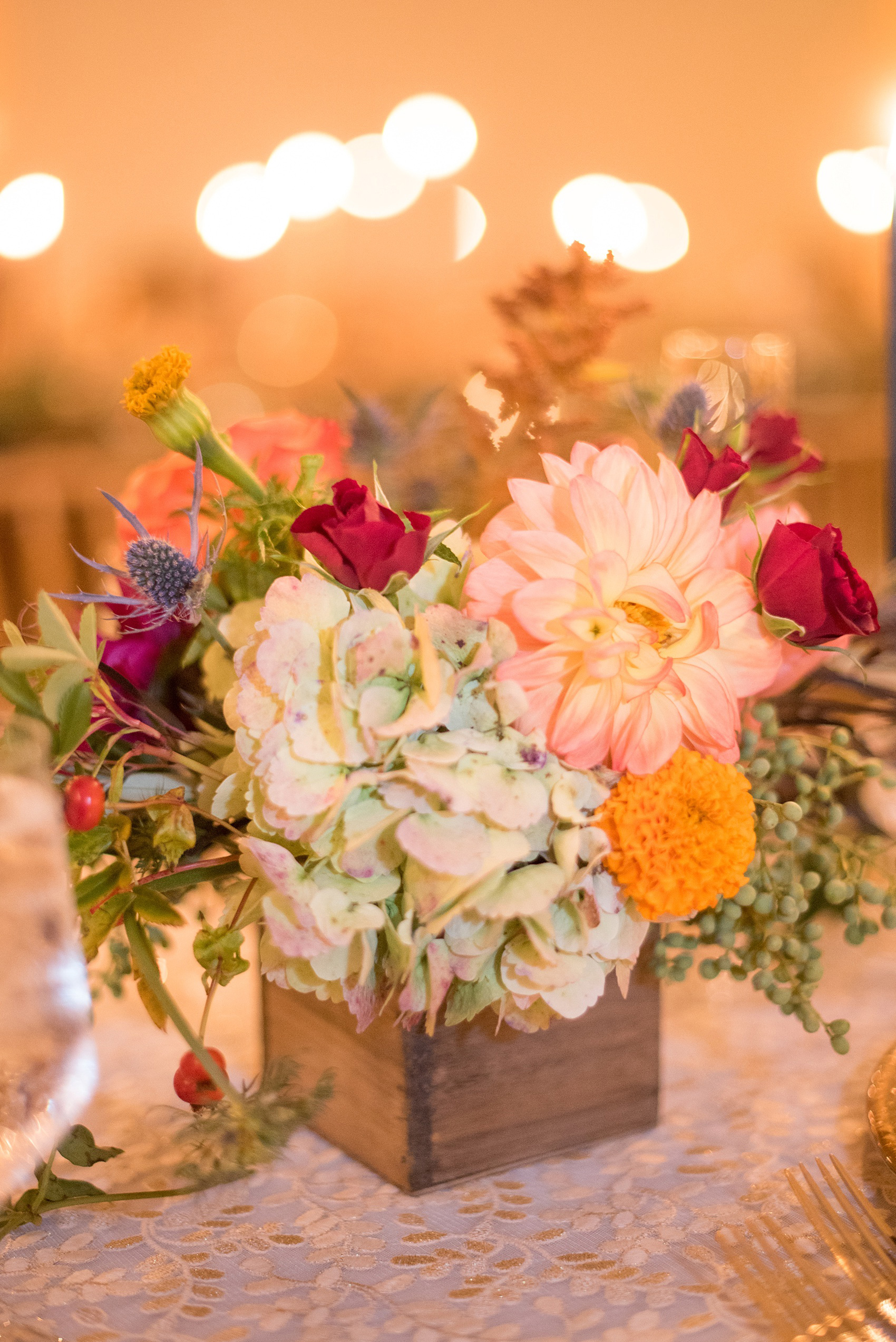 Mikkel Paige Photography photos from a Merrimon-Wynne House wedding in Raleigh. The reception was drenched in romantic candlelight, inside the Carriage House. Tables were decorated with fall flower centerpieces by Meristem Floral.